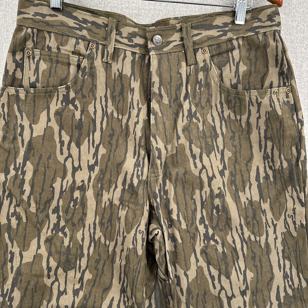 Camouflage-patterned pants on a hanger against a neutral background
