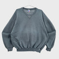 Gray sweatshirt on a hanger with a visible brand label against a neutral background
