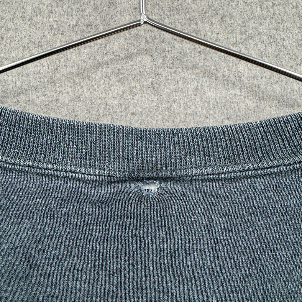rip on the back of sweater connecting tag