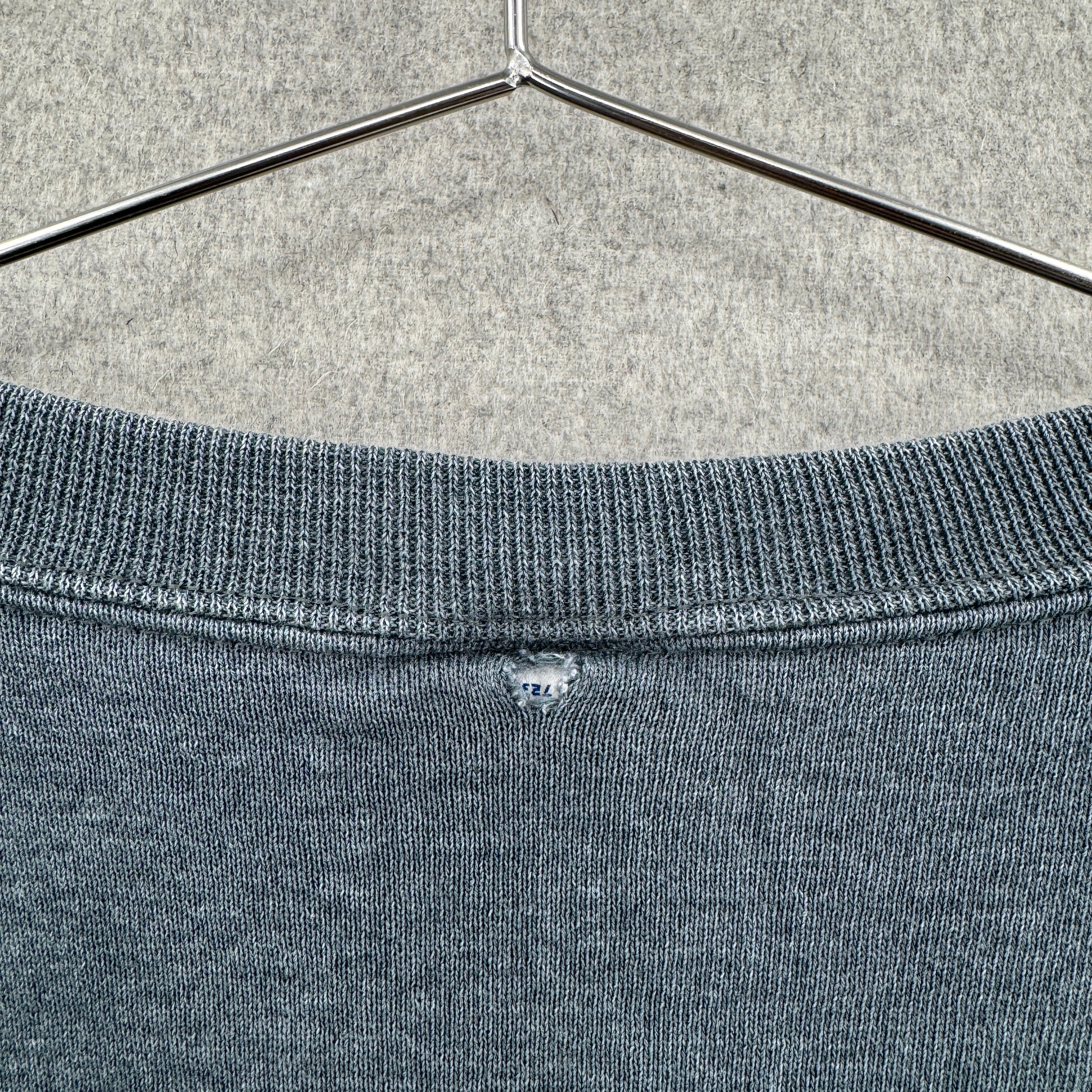 rip on the back of sweater connecting tag