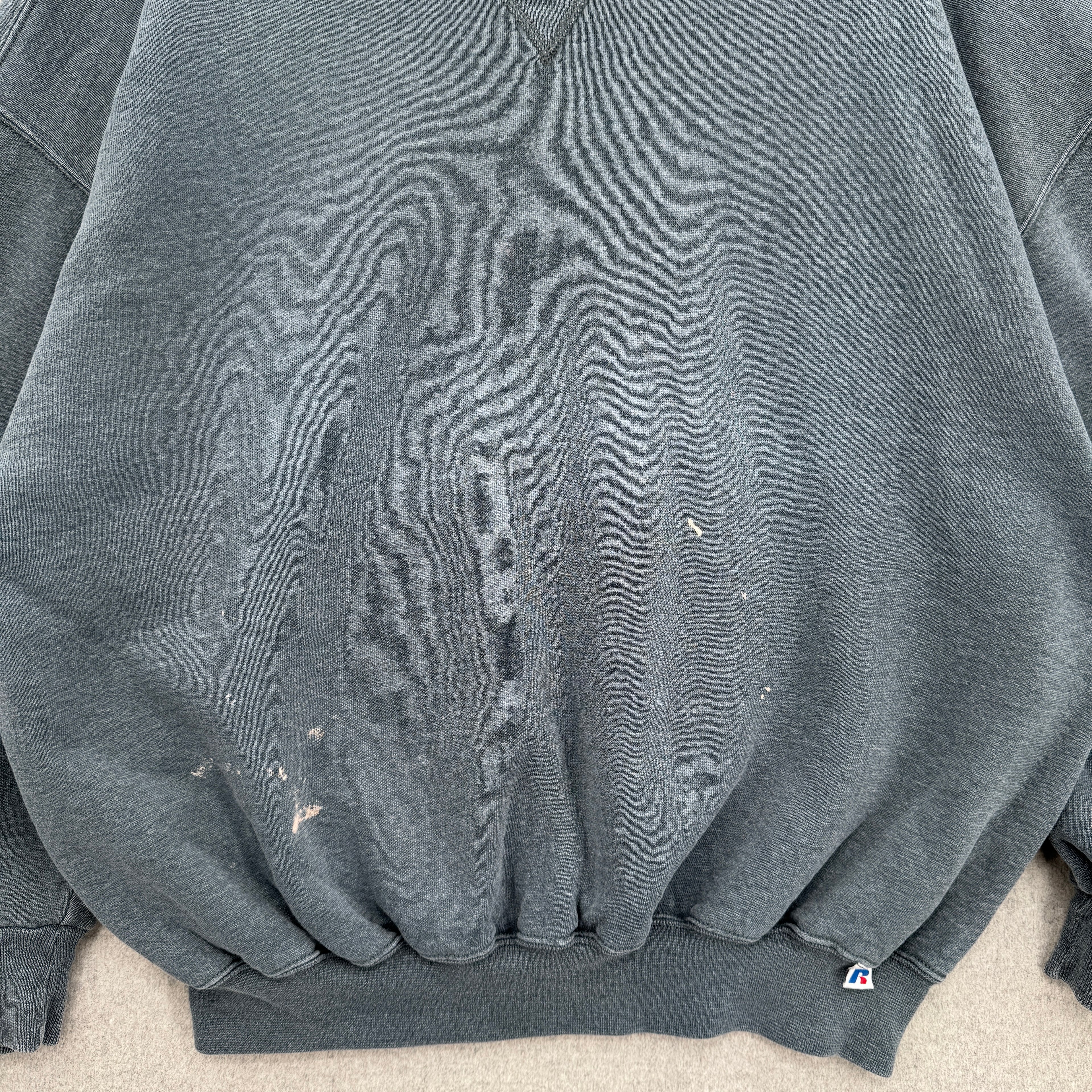 Gray sweatshirt with visible stain spots on the front
