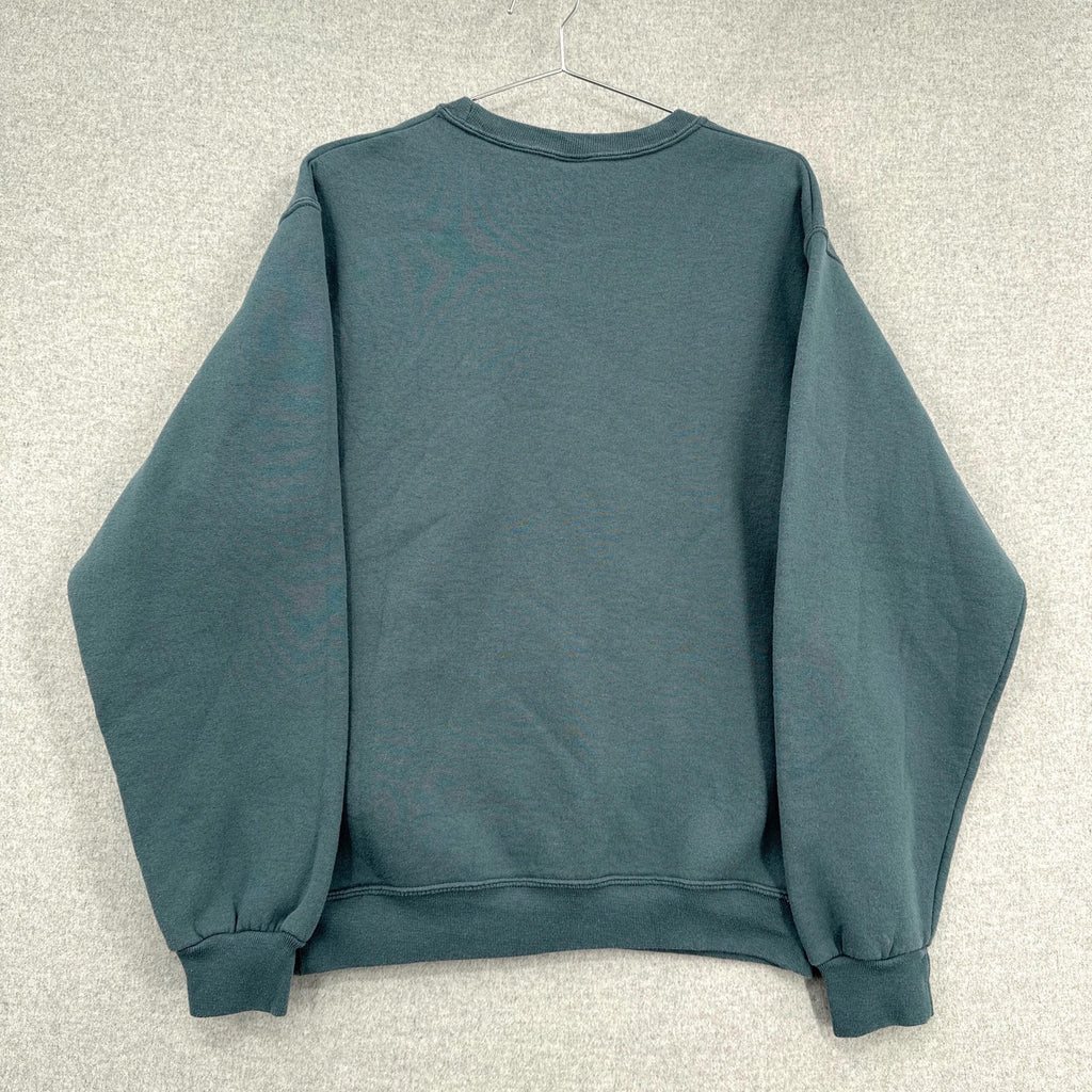Blue sweatshirt on a hanger against a neutral background