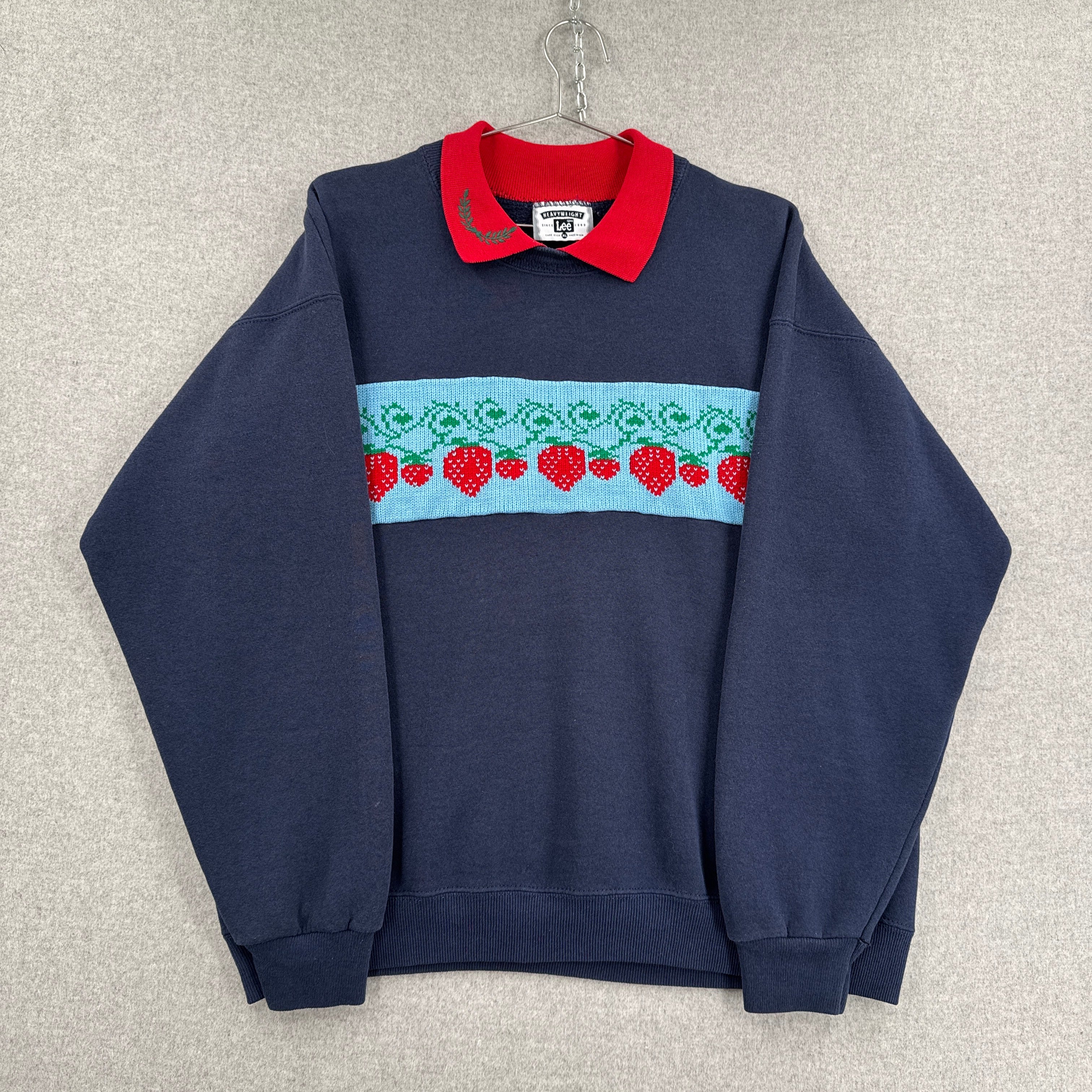 Navy blue shirt with red and white pattern on a light gray background