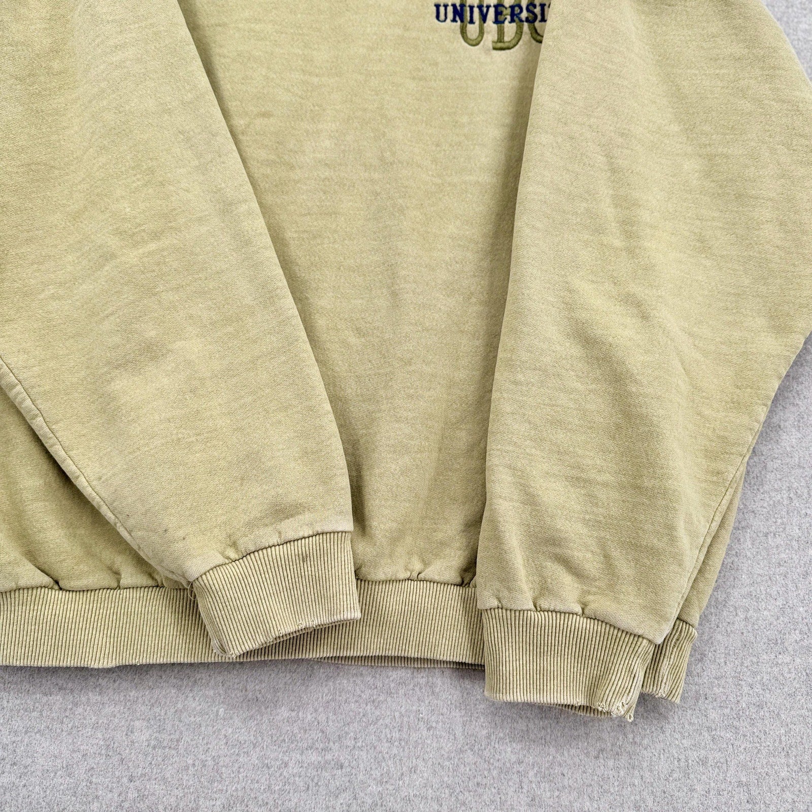 yellowish beige sweatshirt with brand logo