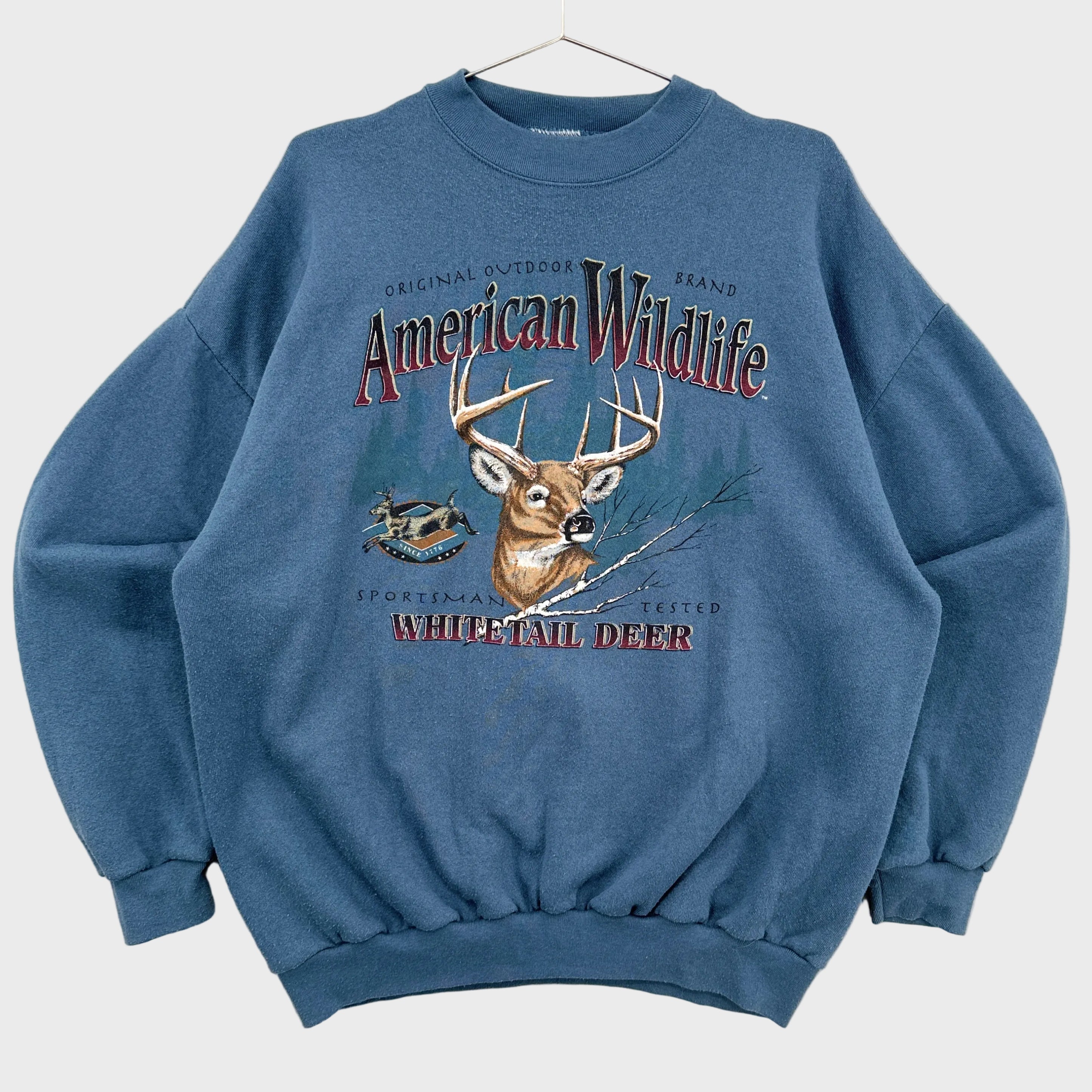 Blue sweatshirt with a deer graphic and 'American Wildlife' text on a white background