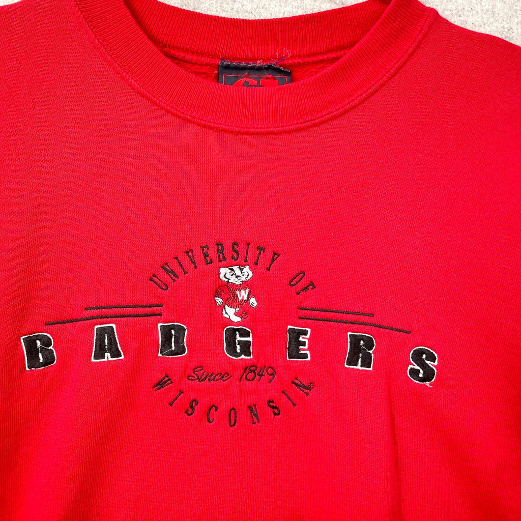 Red sweatshirt with 'University of Badgers' text and logo on a textured surface