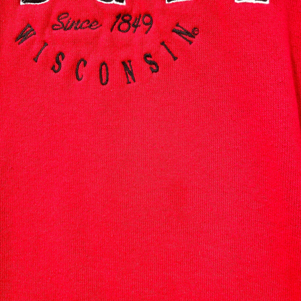 Red fabric with 'WISCONSIN' and 'Since 1849' text embroidered on it