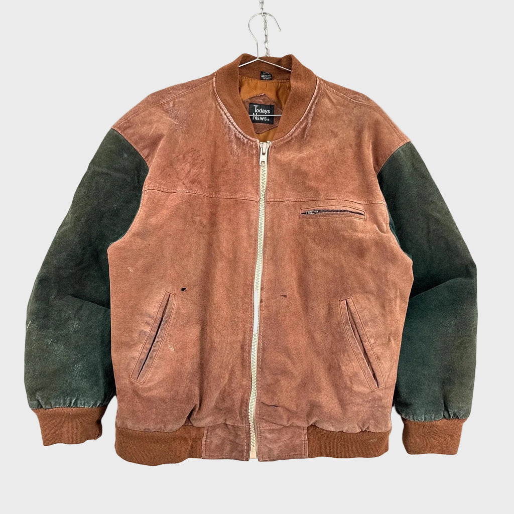 Two-tone brown and green jacket on a hanger against a light gray background