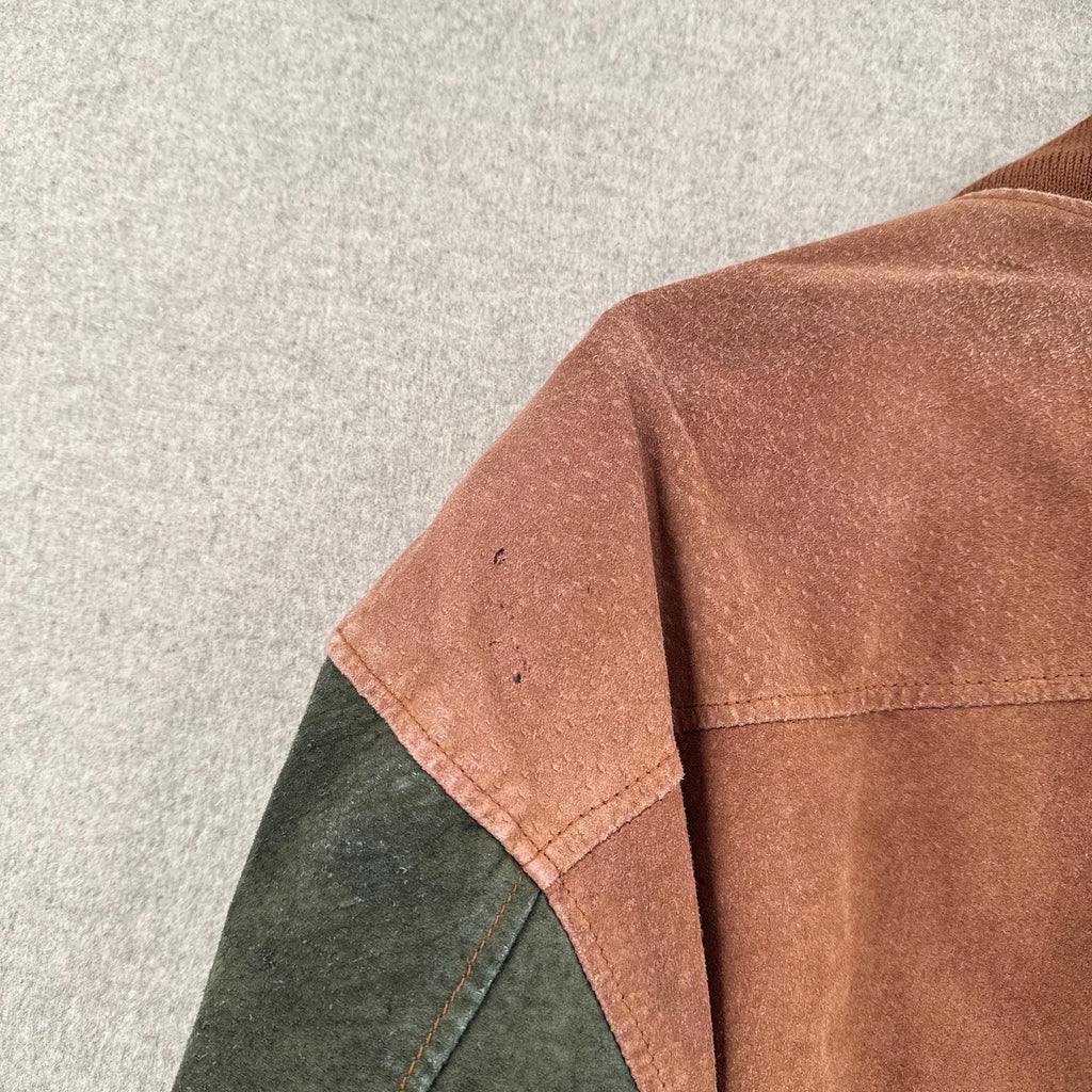 Close-up of a brown and green jacket on a light gray background