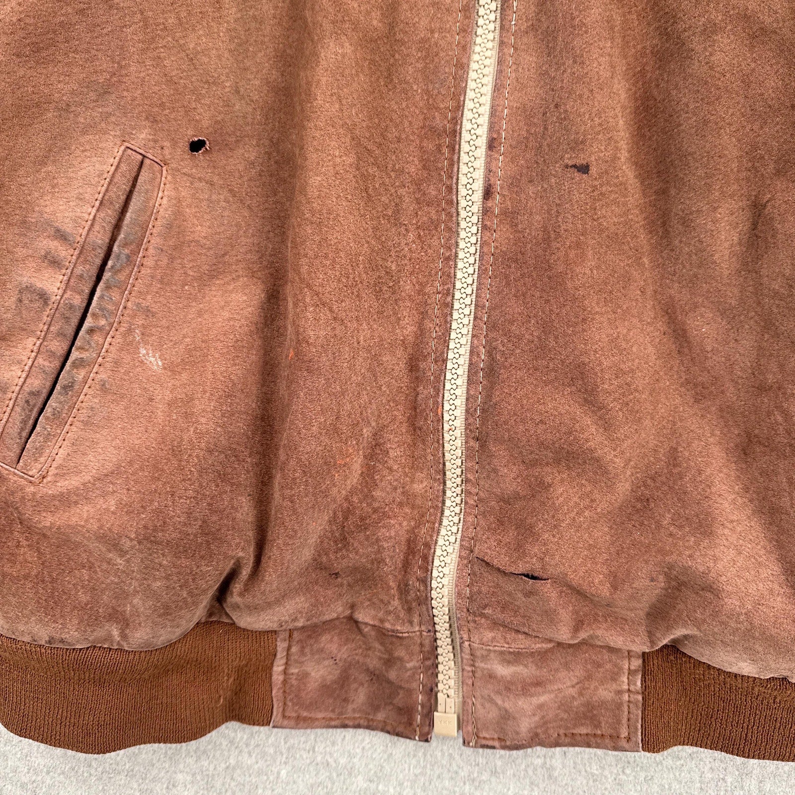 rips and stains on front of jacket