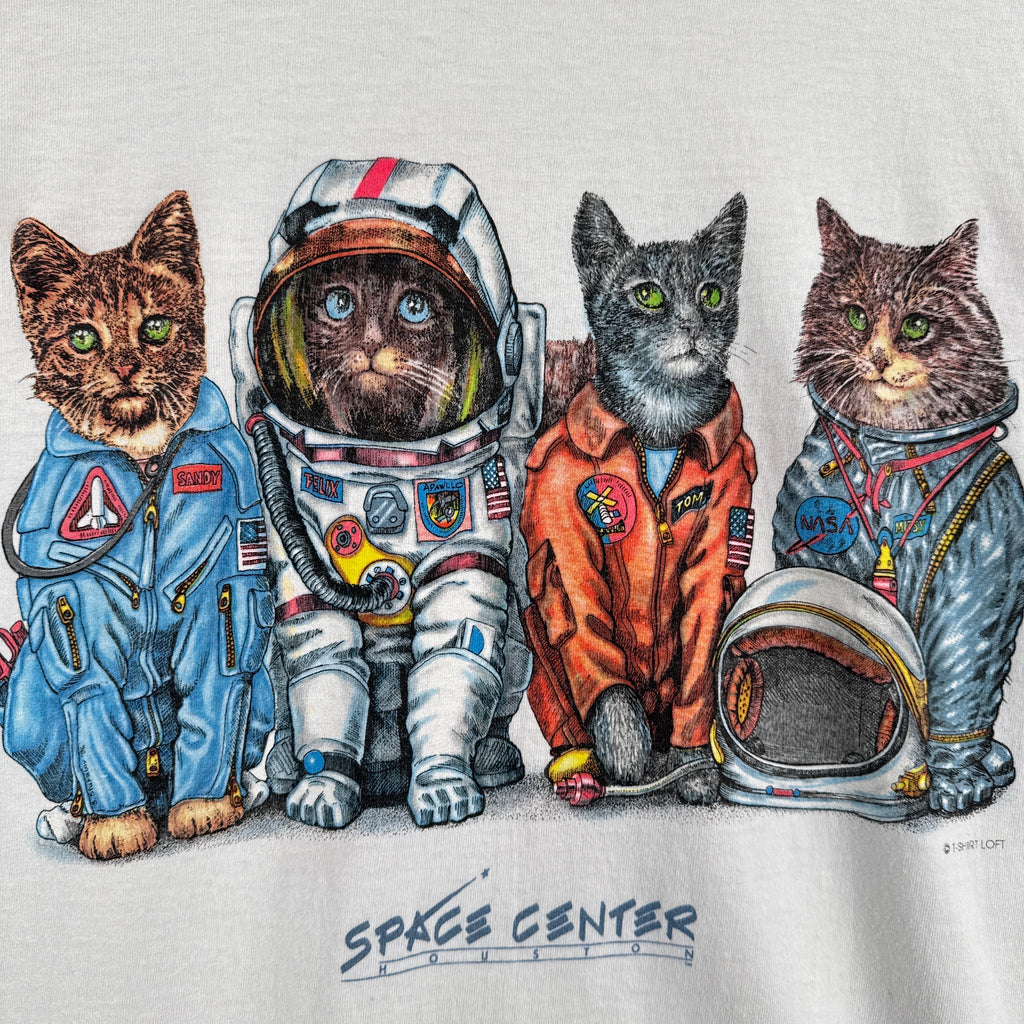Four cats in astronaut costumes on a white background with 'Space Center' text.