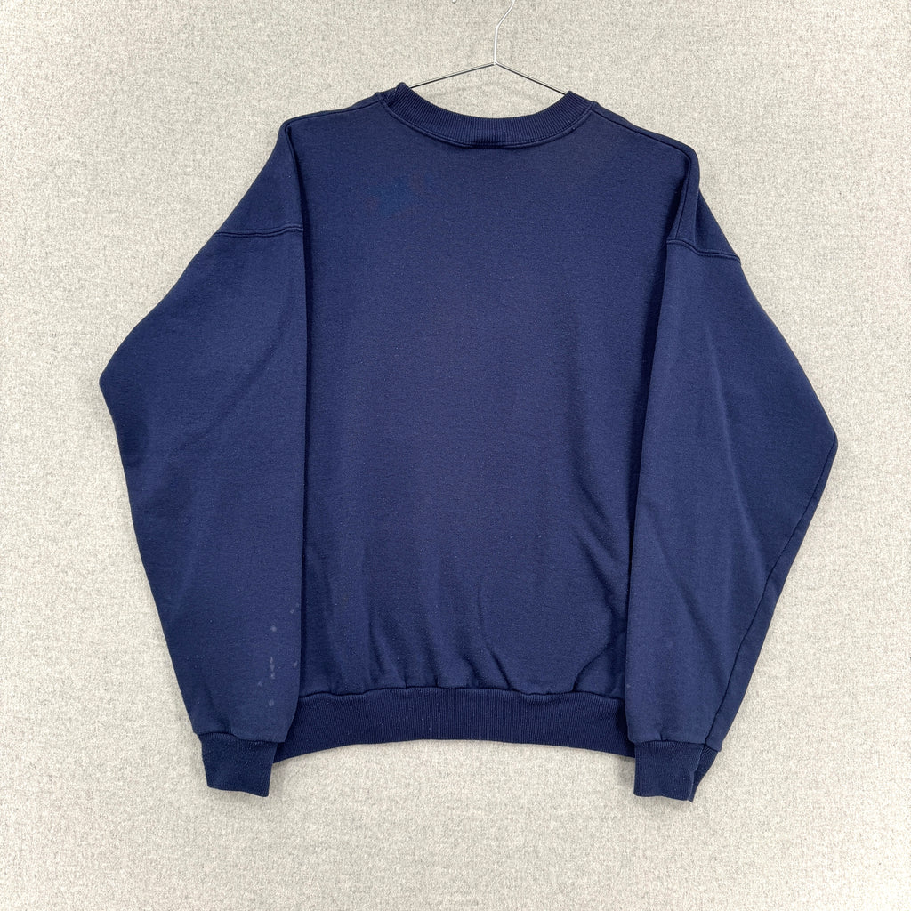 Navy blue sweatshirt on a beige textured background. no design on the back.