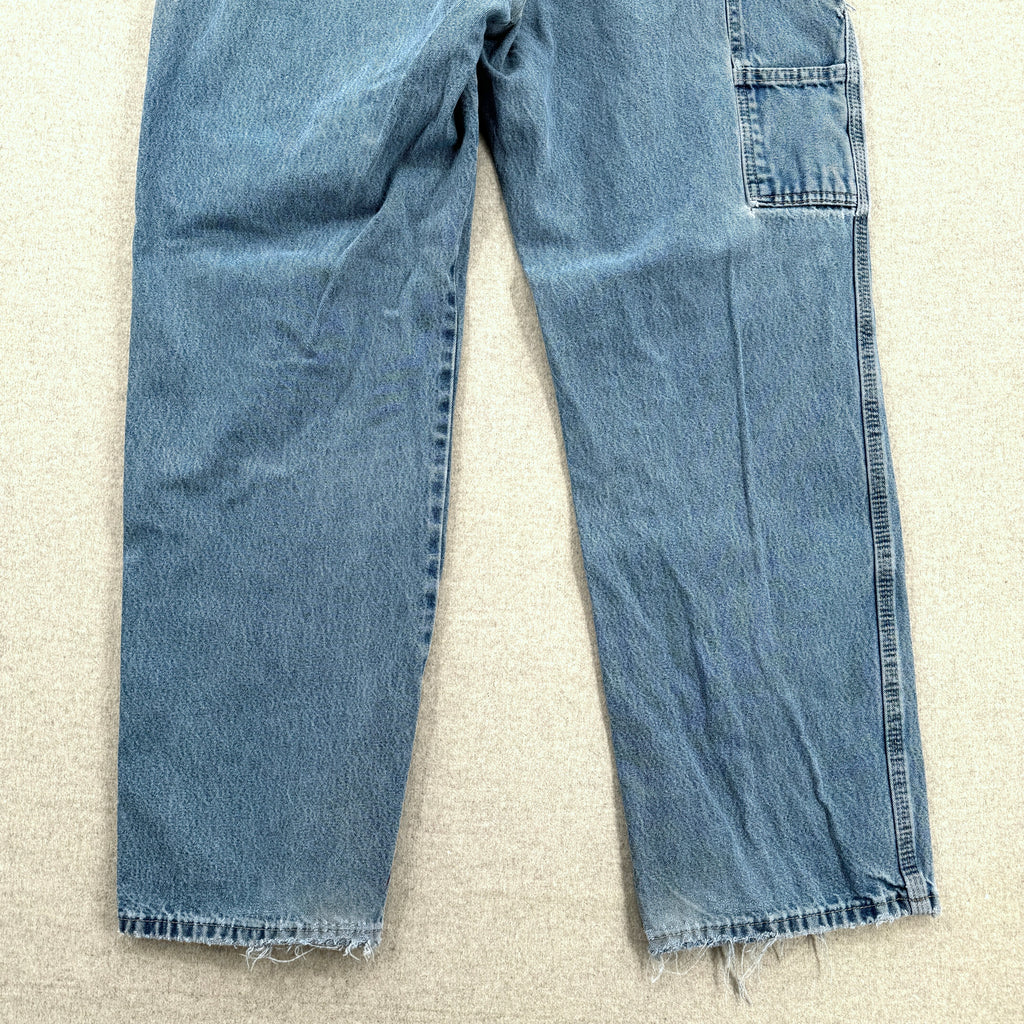 Pair of blue jeans on a beige carpet bottom back