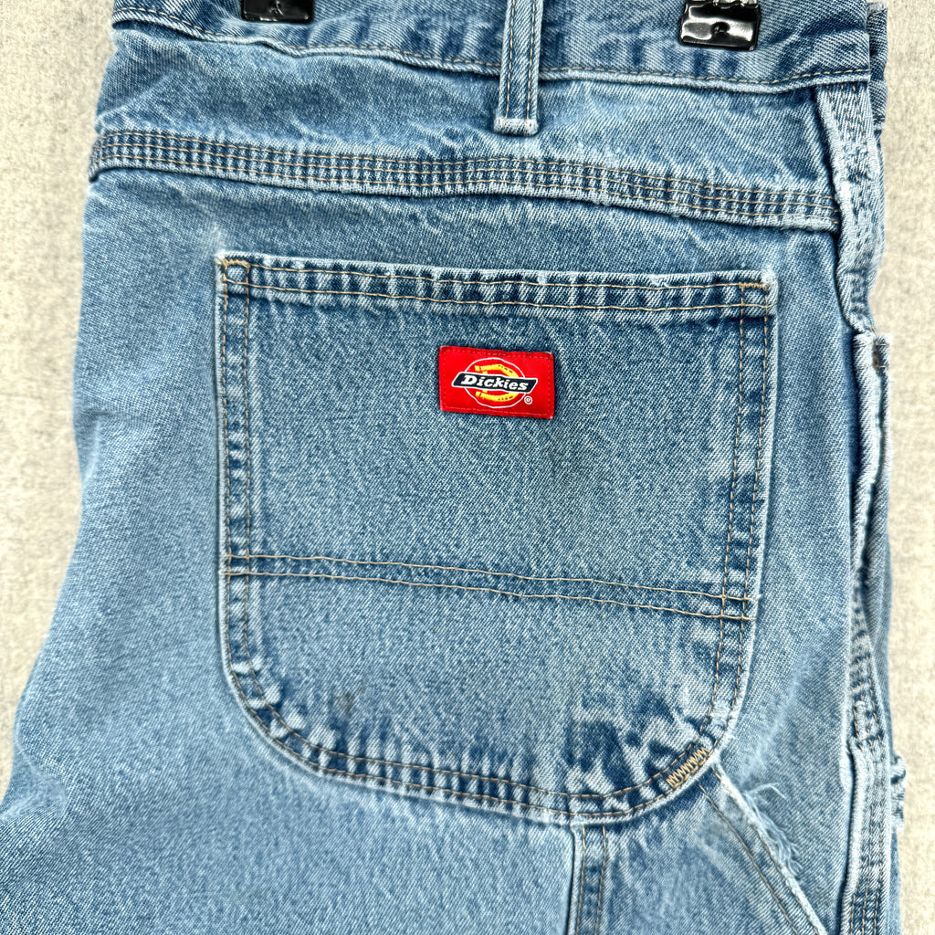 Blue denim pocket with a Dickies logo on a beige background