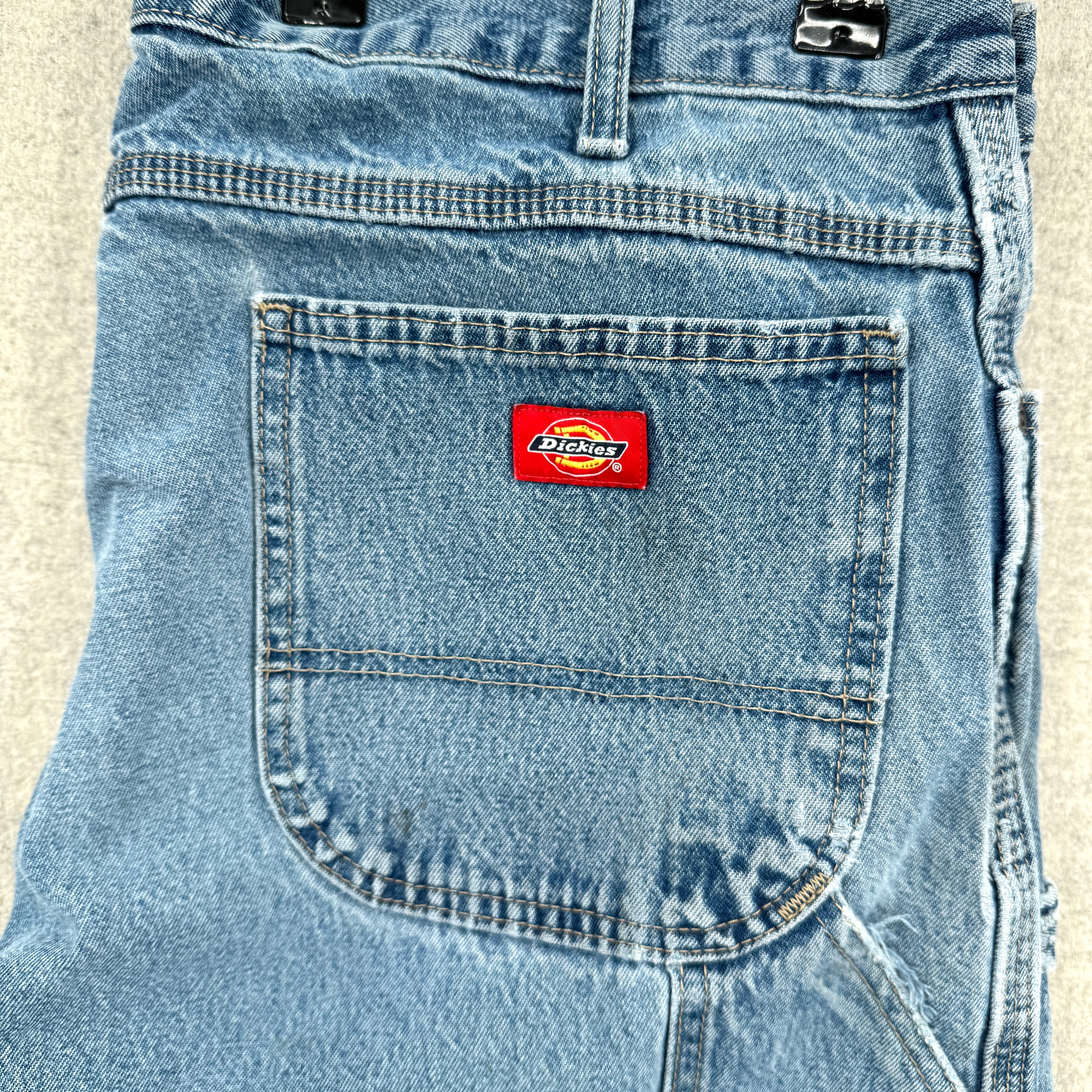 Blue denim pocket with a Dickies logo on a beige background