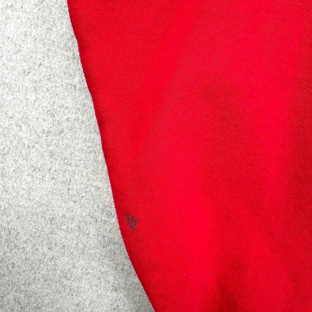 Red fabric with a small stain spot on a gray surface
