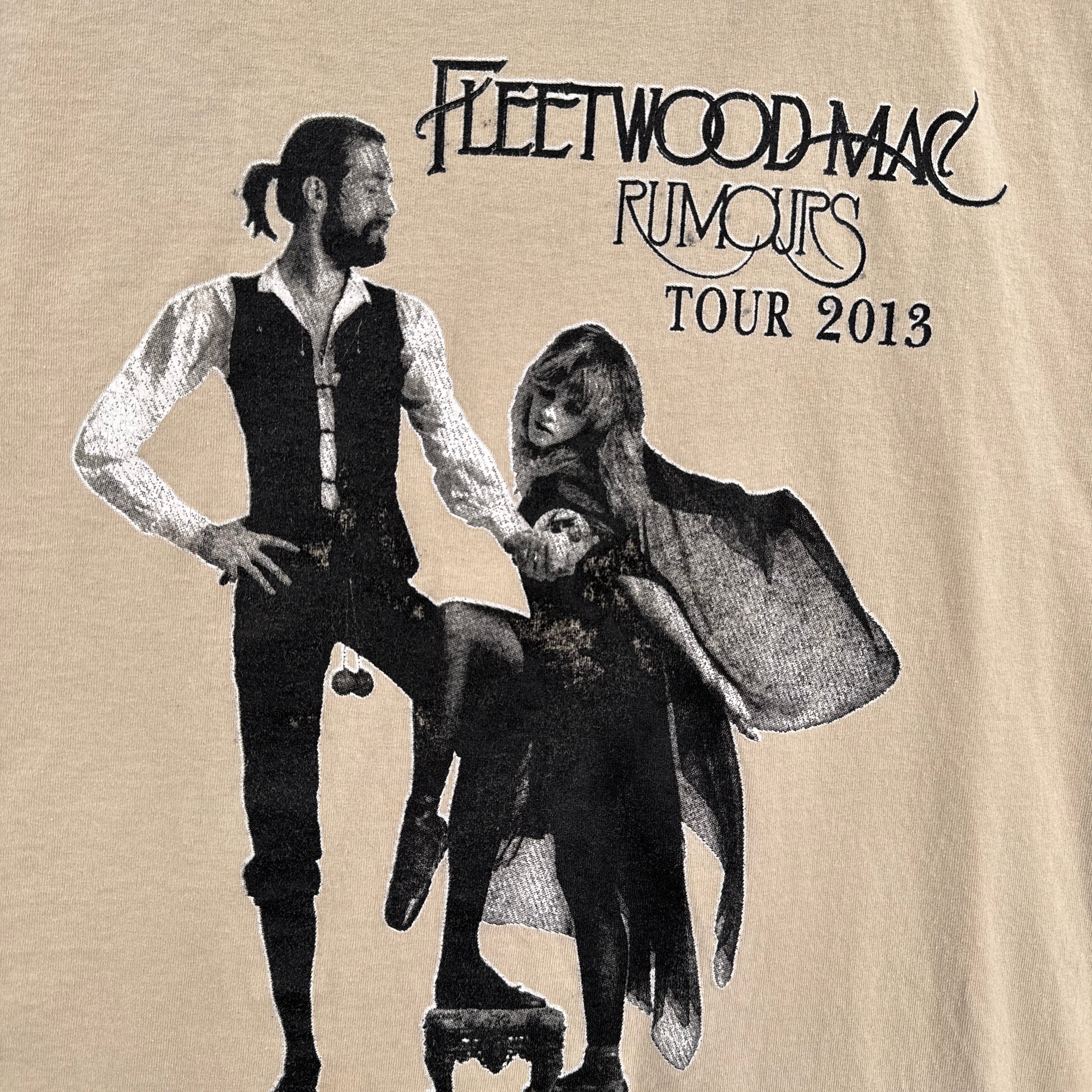 Promotional graphic for Fleetwood Mac Rumours Tour 2013 featuring a stylized illustration of a man and woman.