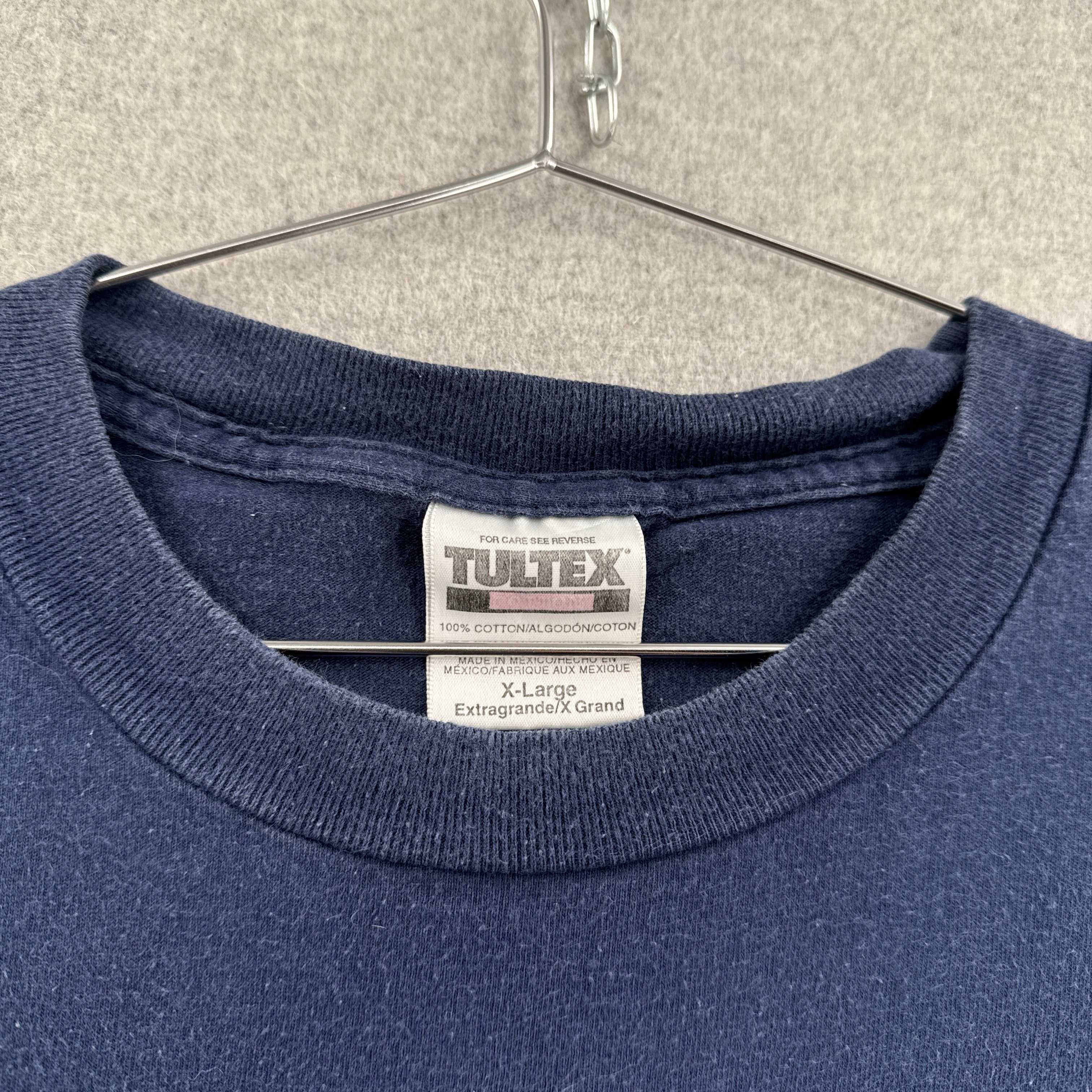 Blue t-shirt with Tultex label on a hanger. Size XL