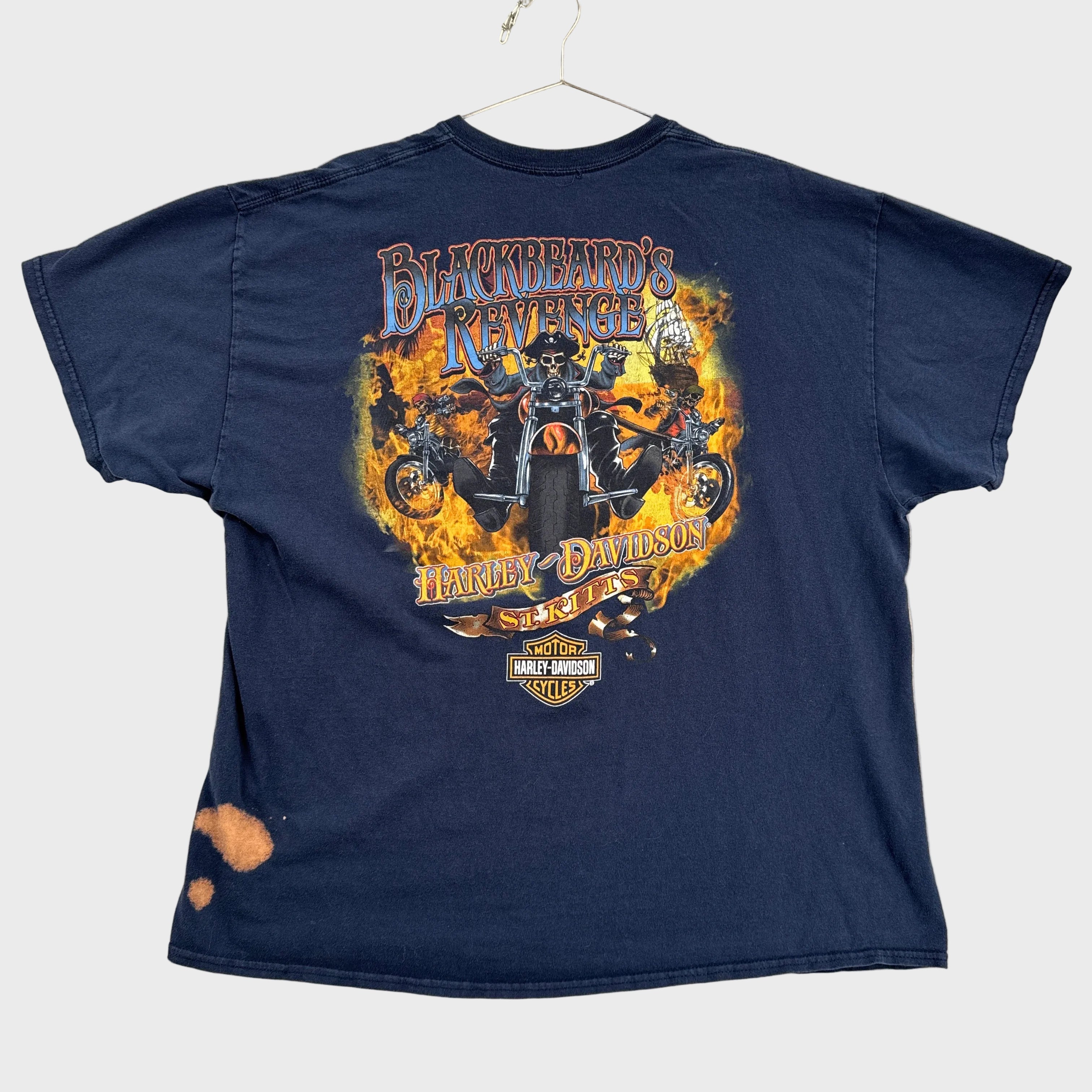 Navy blue tank top with a graphic design on a beige surface
