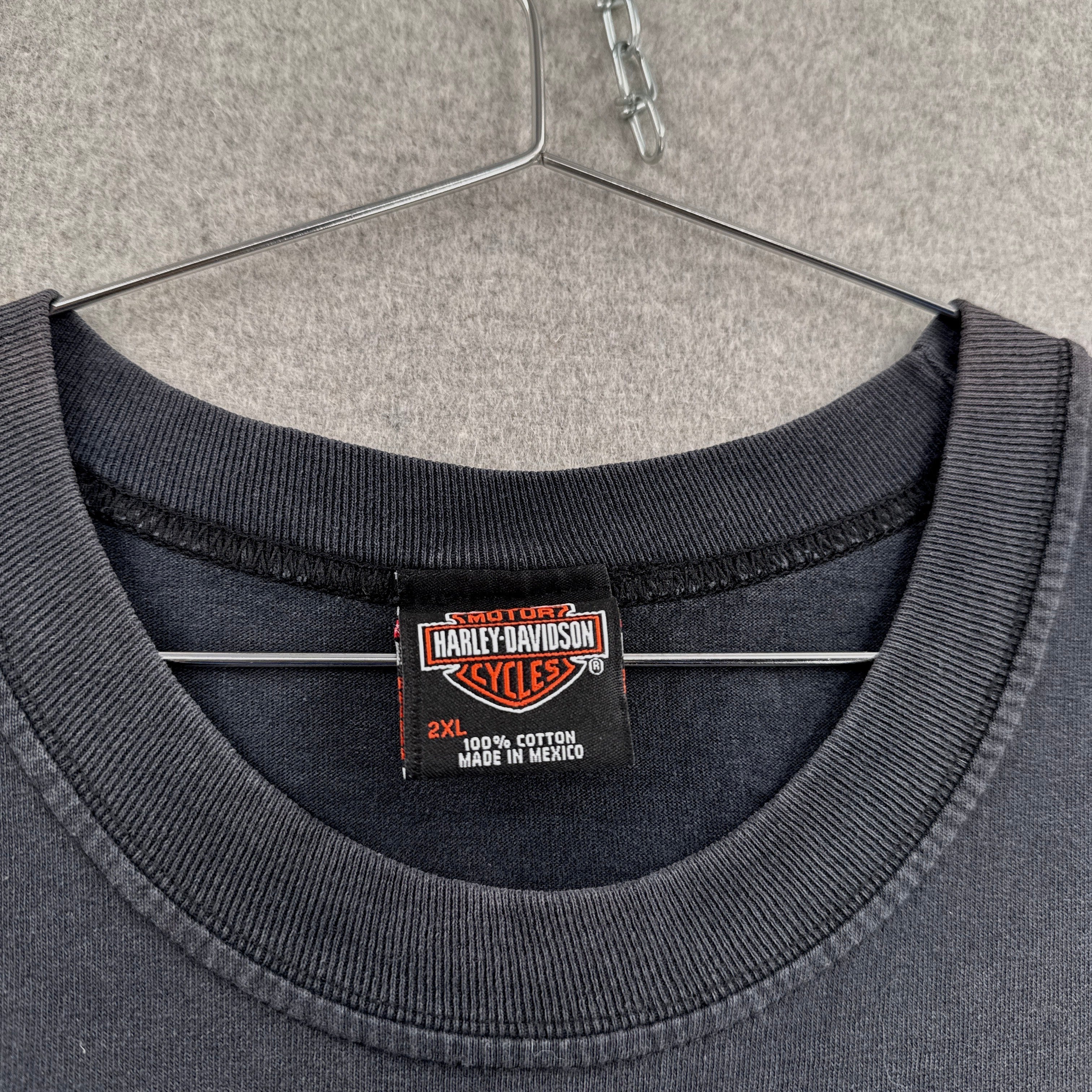 Harley Davidson label on a gray sweatshirt with a hanger in the background. Size 2XL