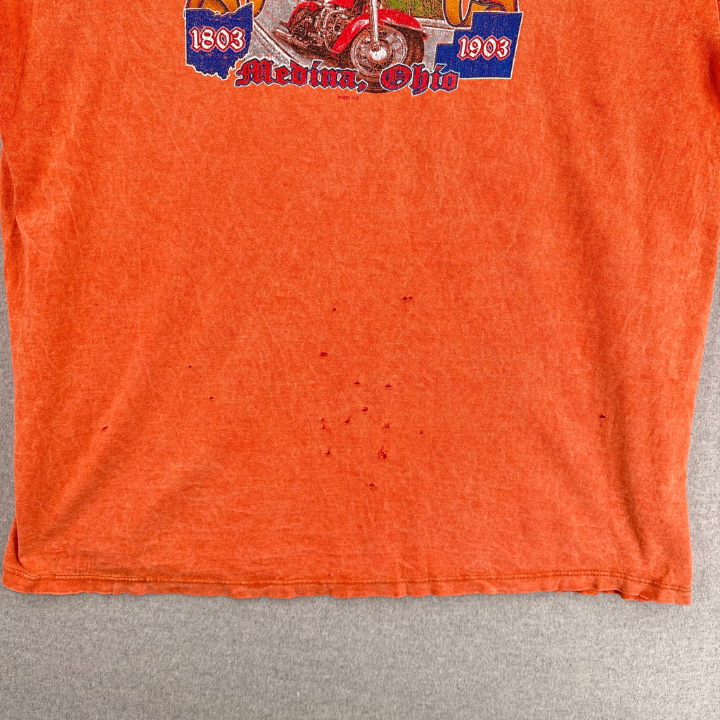 back of shirt shows many small holes