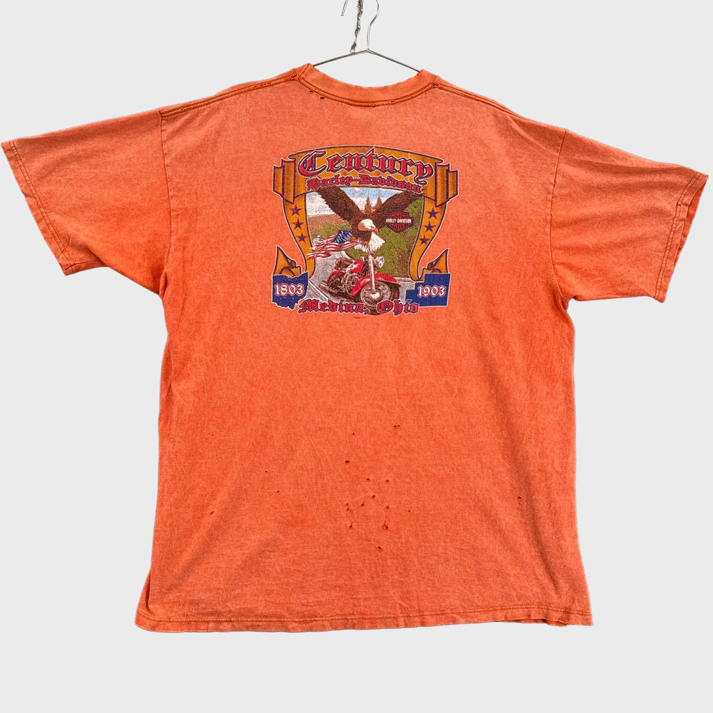 Orange t-shirt with graphic design on a gray background