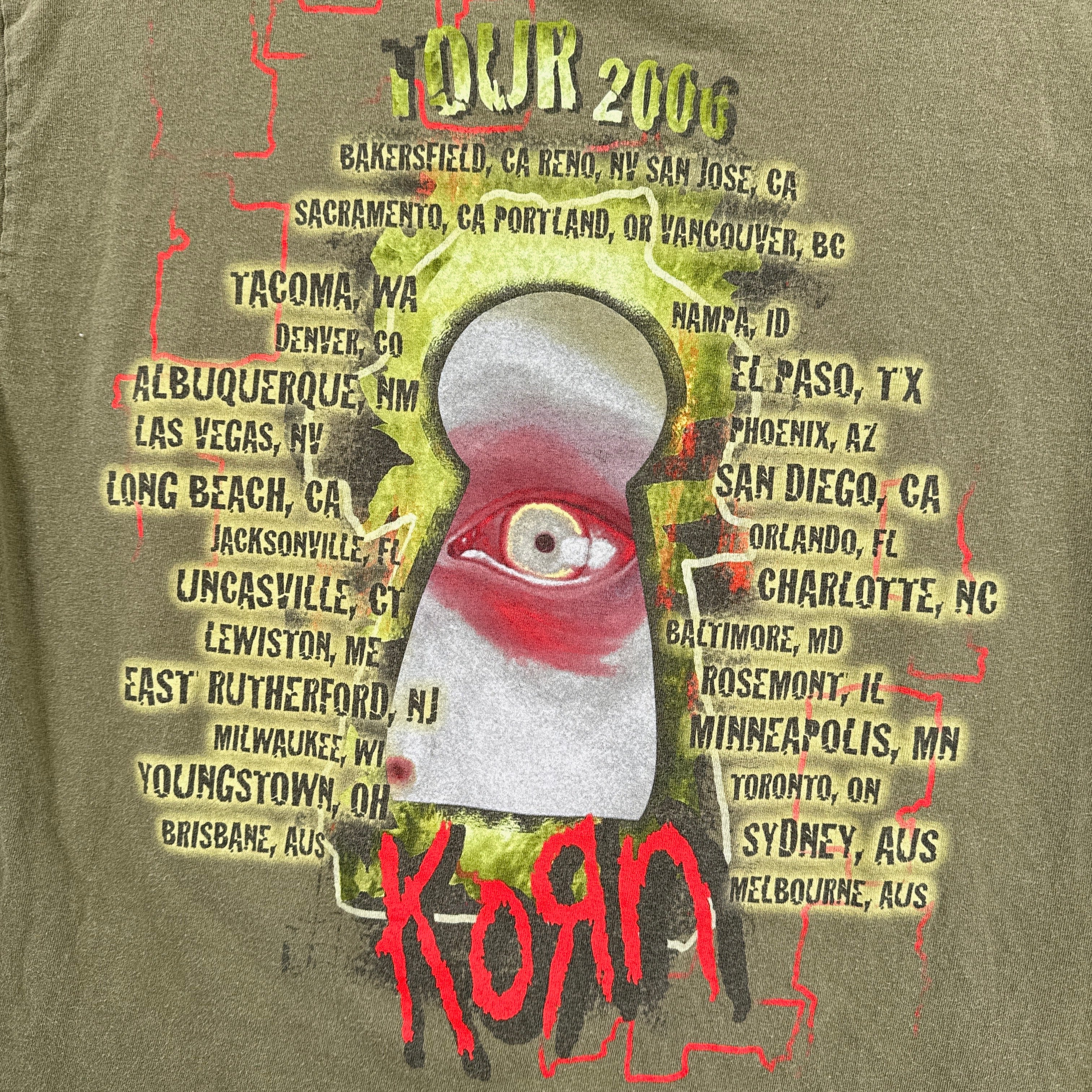 T-shirt with tour dates and 'Korn' branding on a green background