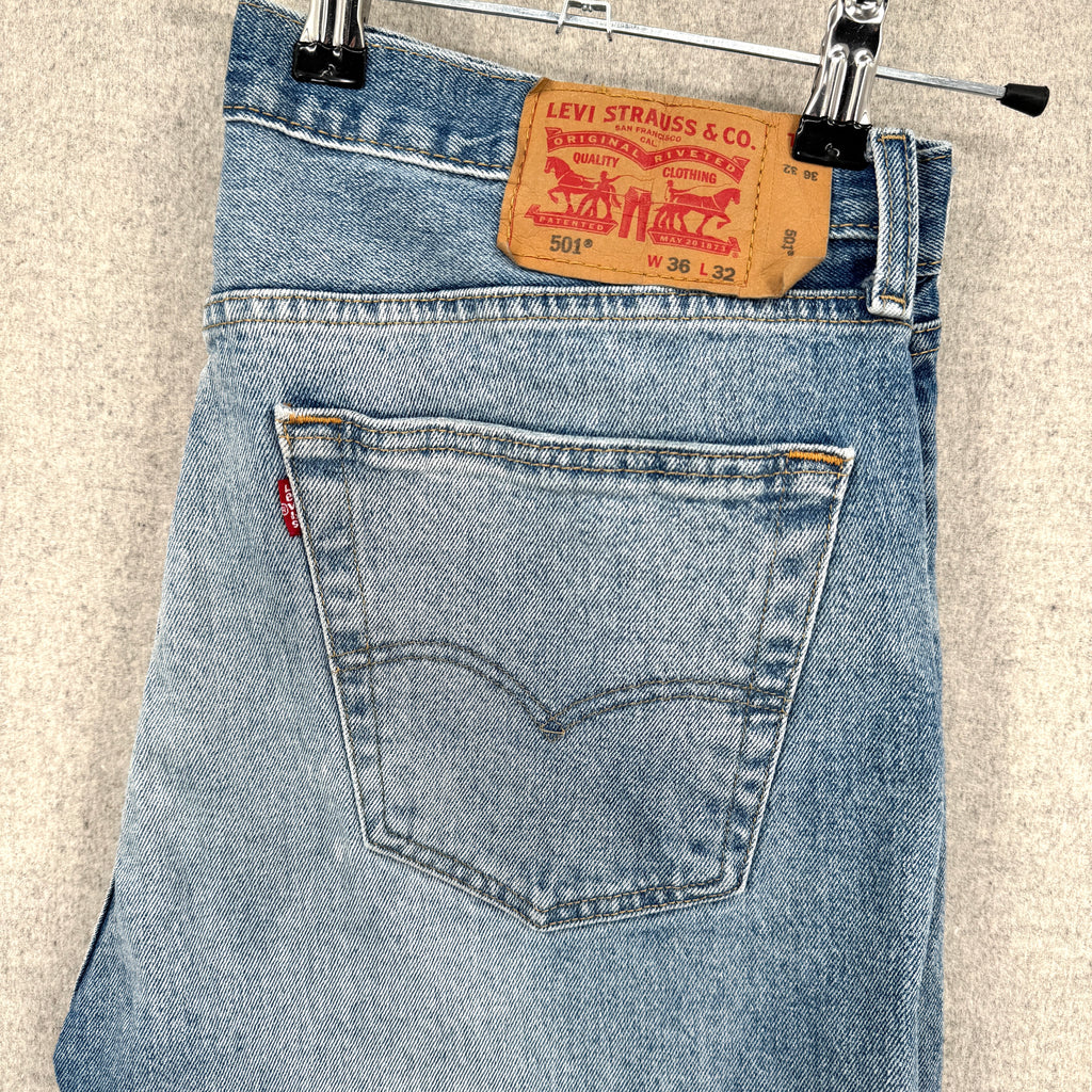 Blue Levi's jeans with a brand tag on a beige background