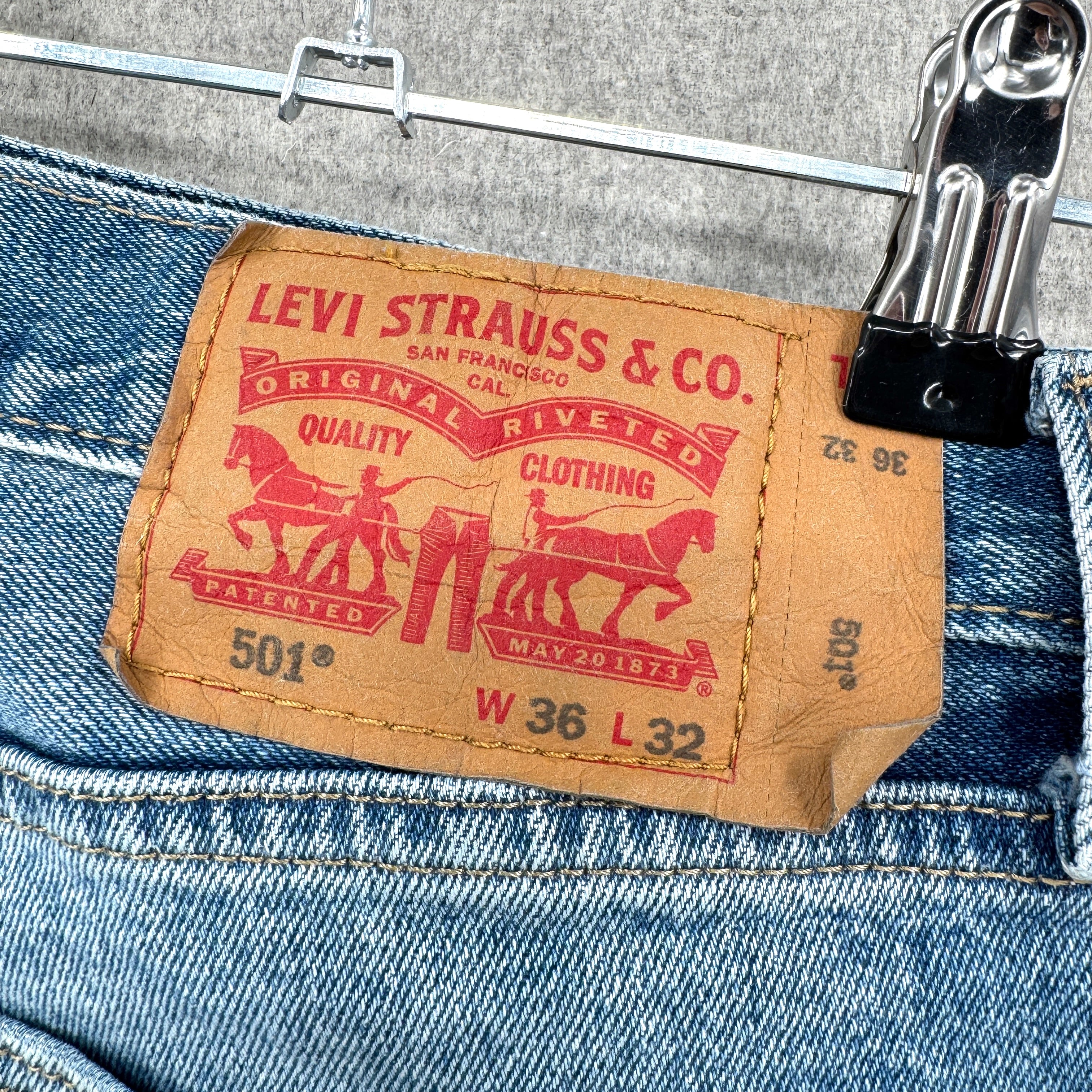 Levi's jeans label with brand logo and text on a denim background. 501 style