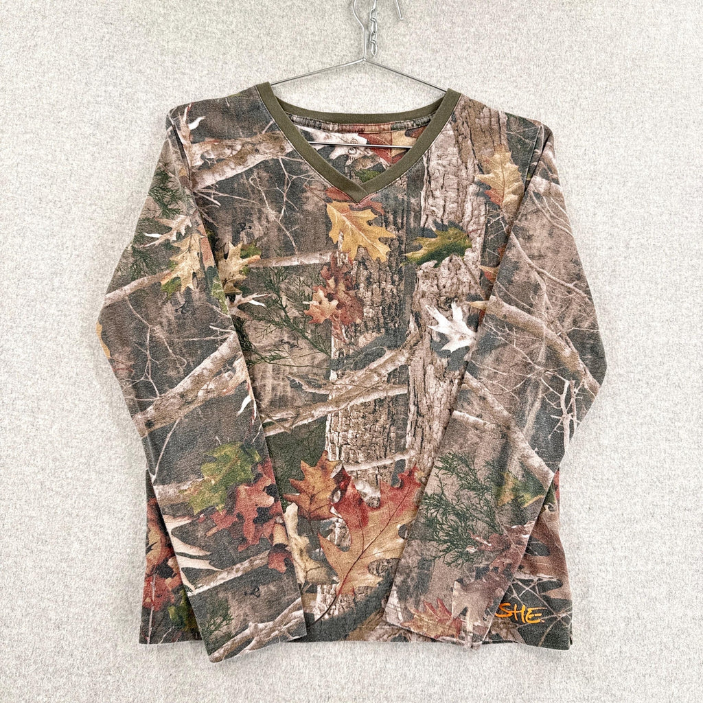 Camouflage-patterned long-sleeve shirt on a hanger against a light background