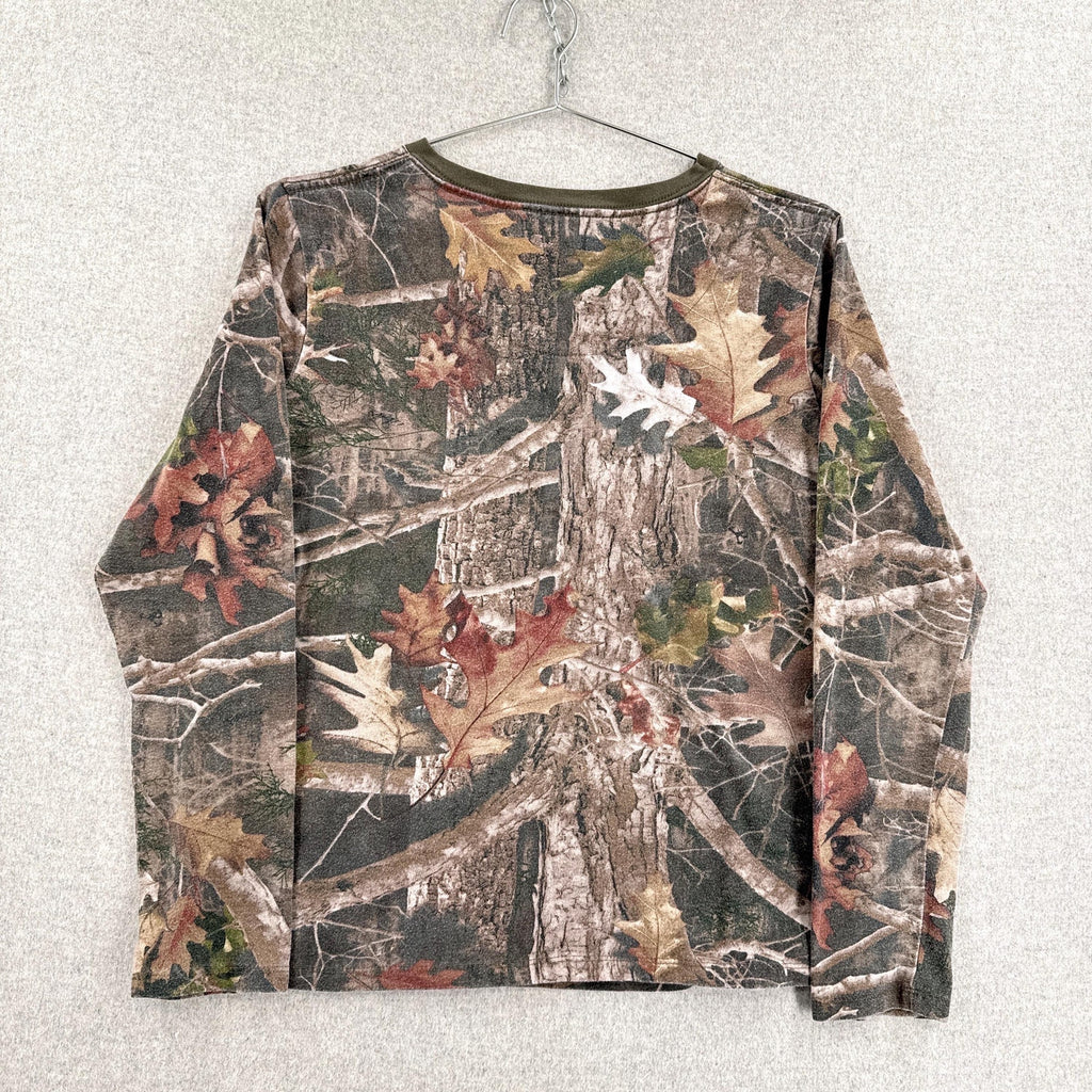 Camouflage-patterned shirt on a hanger against a light gray background