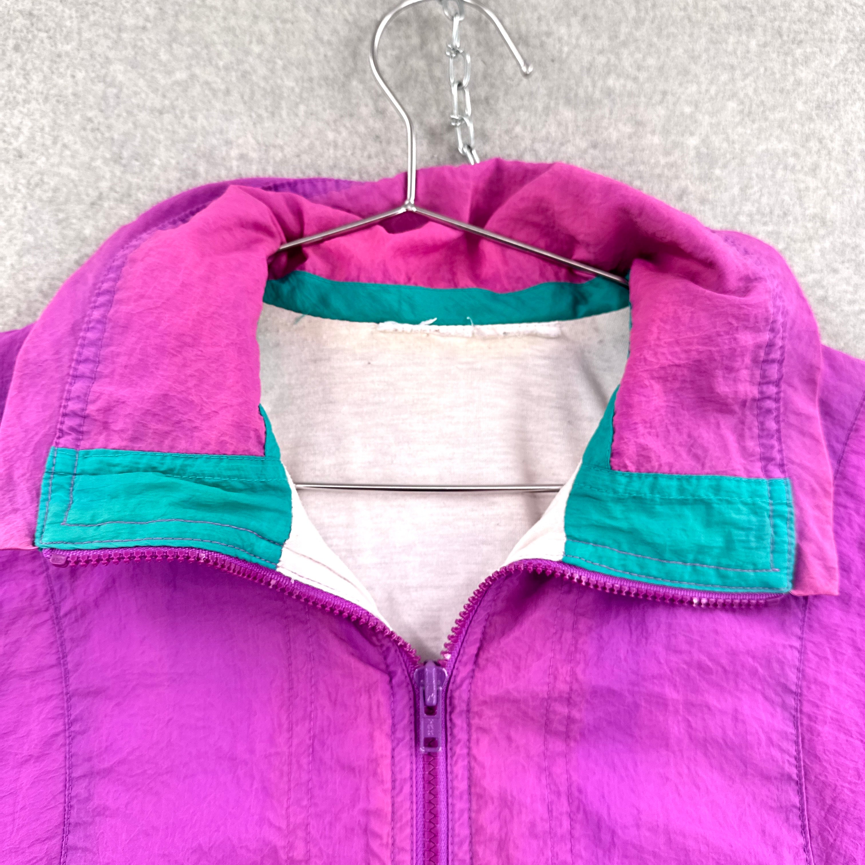 Purple jacket with teal accents on a hanger against a textured white background