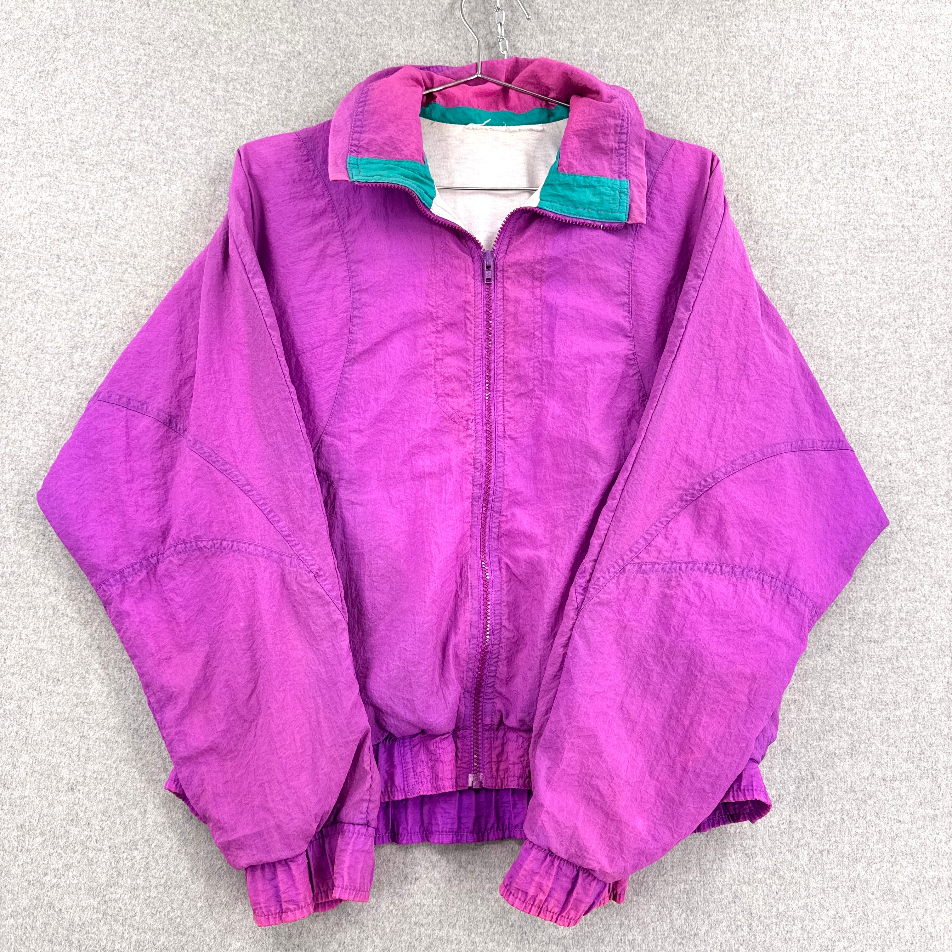 Purple jacket with green lining on a gray background