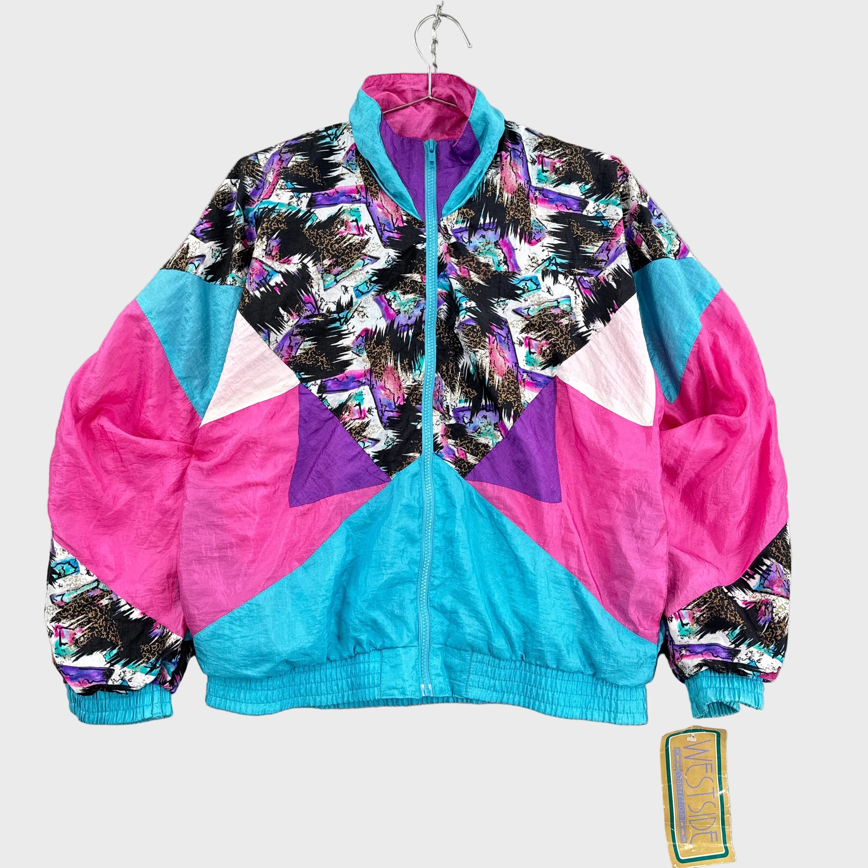 Colorful neon retro windbreaker jacket with geometric pattern on a gray surface