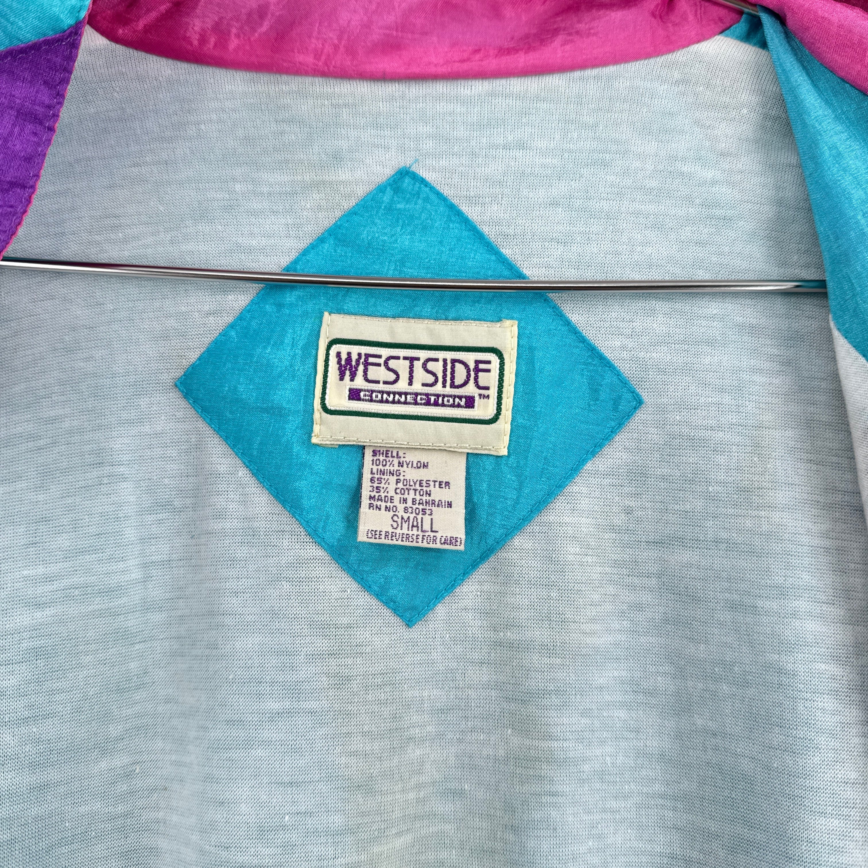 Close-up of a fabric with a Westside label on a gray background. Size small Nylon shell cotton lining