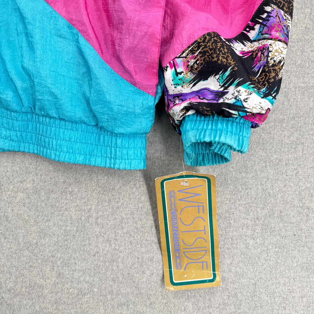 Colorful jacket with a 'Westside' tag on a gray surface
