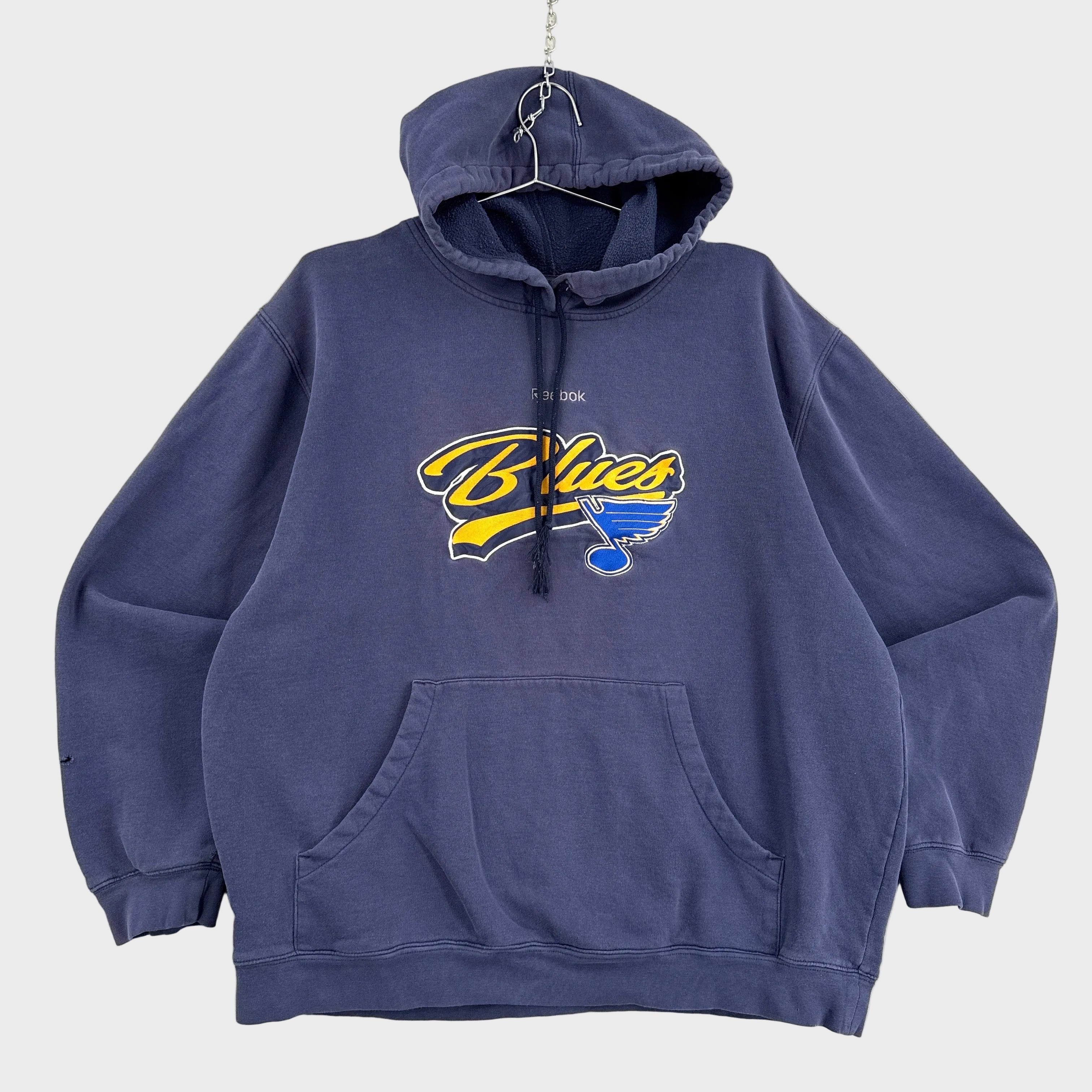 Navy blue hoodie with 'Blues' logo on a light gray background. St Louis team Reebok