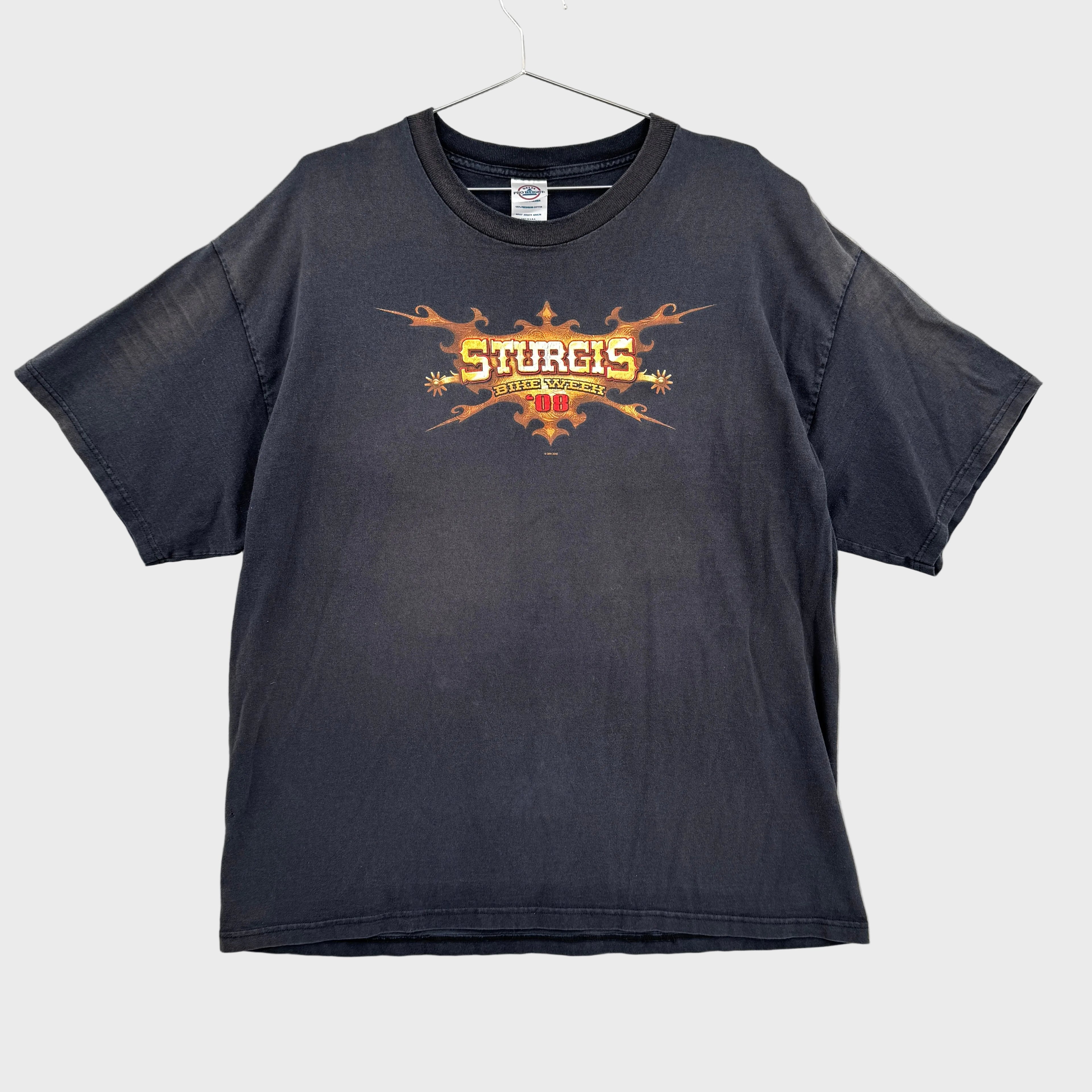 Black t-shirt with 'Sturgis bike week' graphic design on a gray textured background