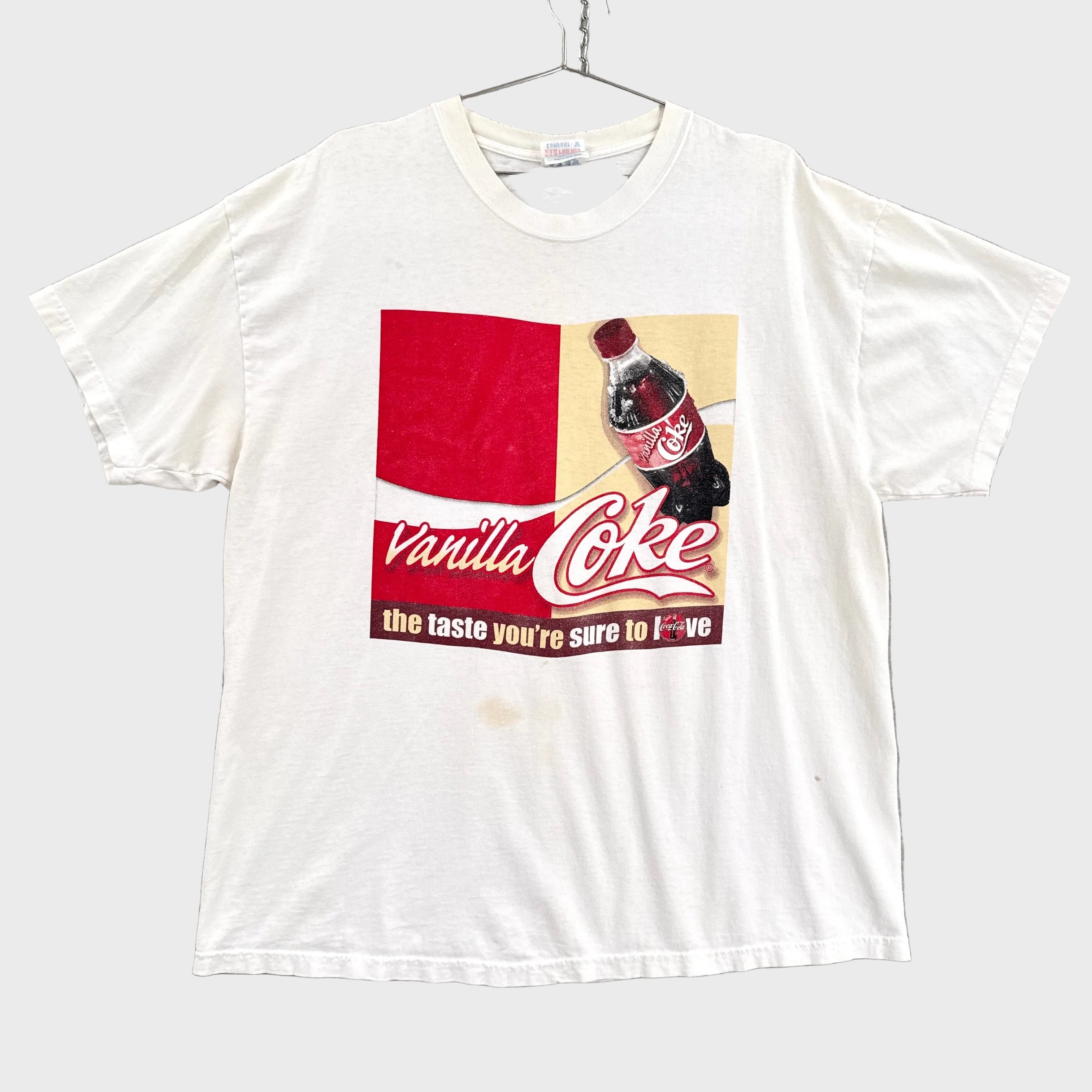White t-shirt with Vanilla Coke graphic on a gray background