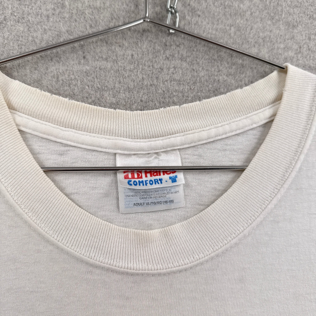 Close-up of a gray sweatshirt with a brand label on a gray background. Hanes tag adult size XL