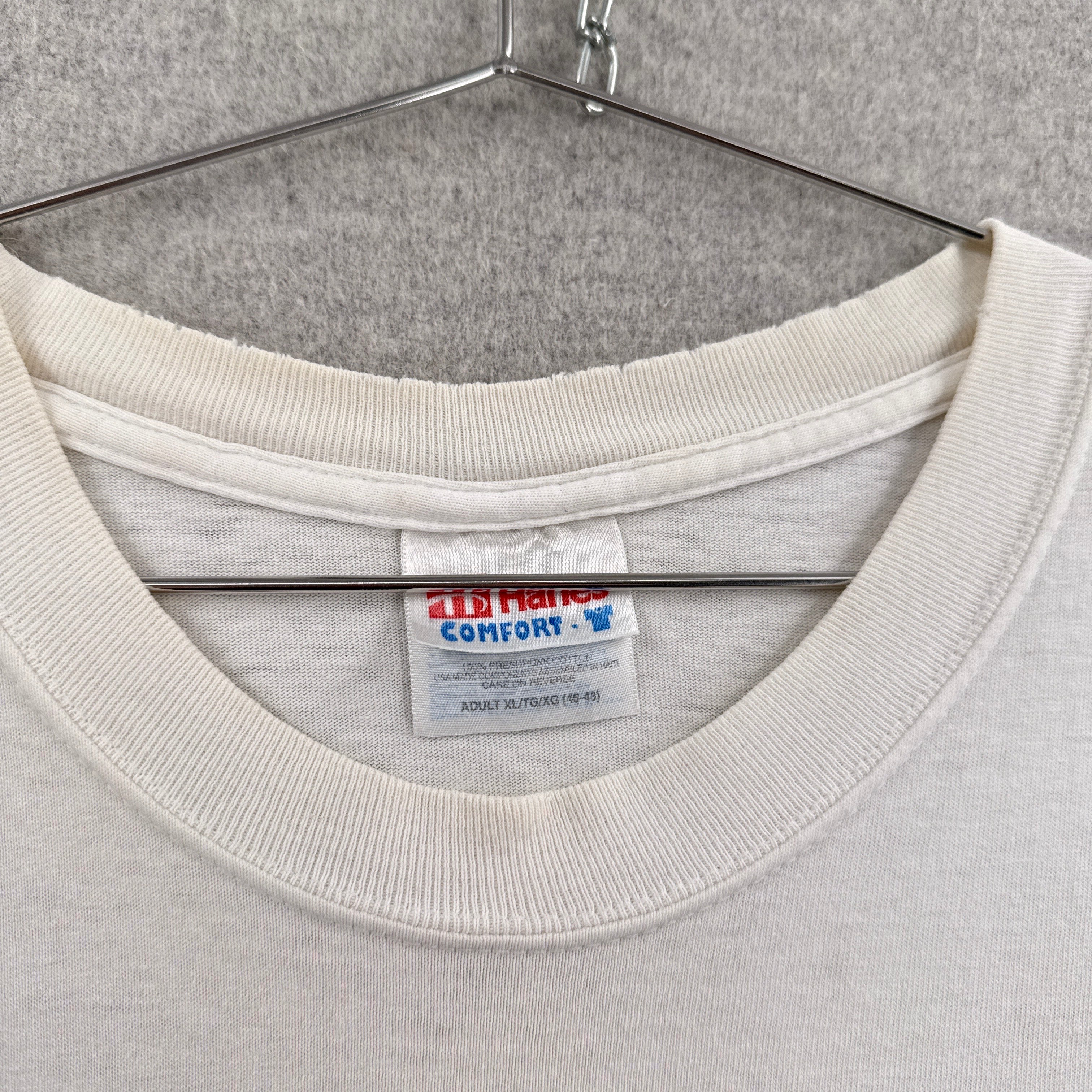 Close-up of a gray sweatshirt with a brand label on a gray background. Hanes tag adult size XL