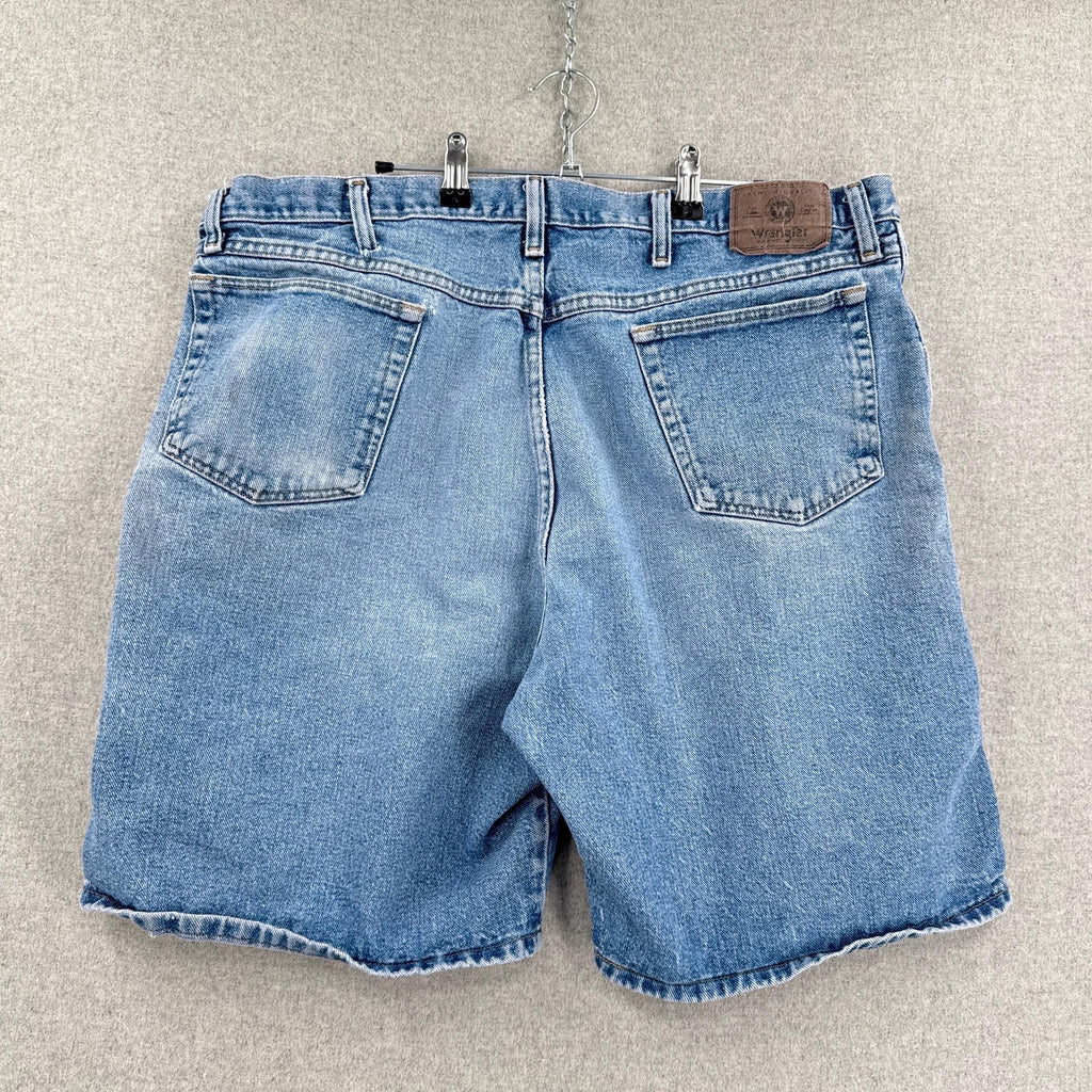 Blue denim shorts on a hanger against a neutral background