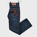 Blue jeans with orange logo on pocket, hanging against a textured white background