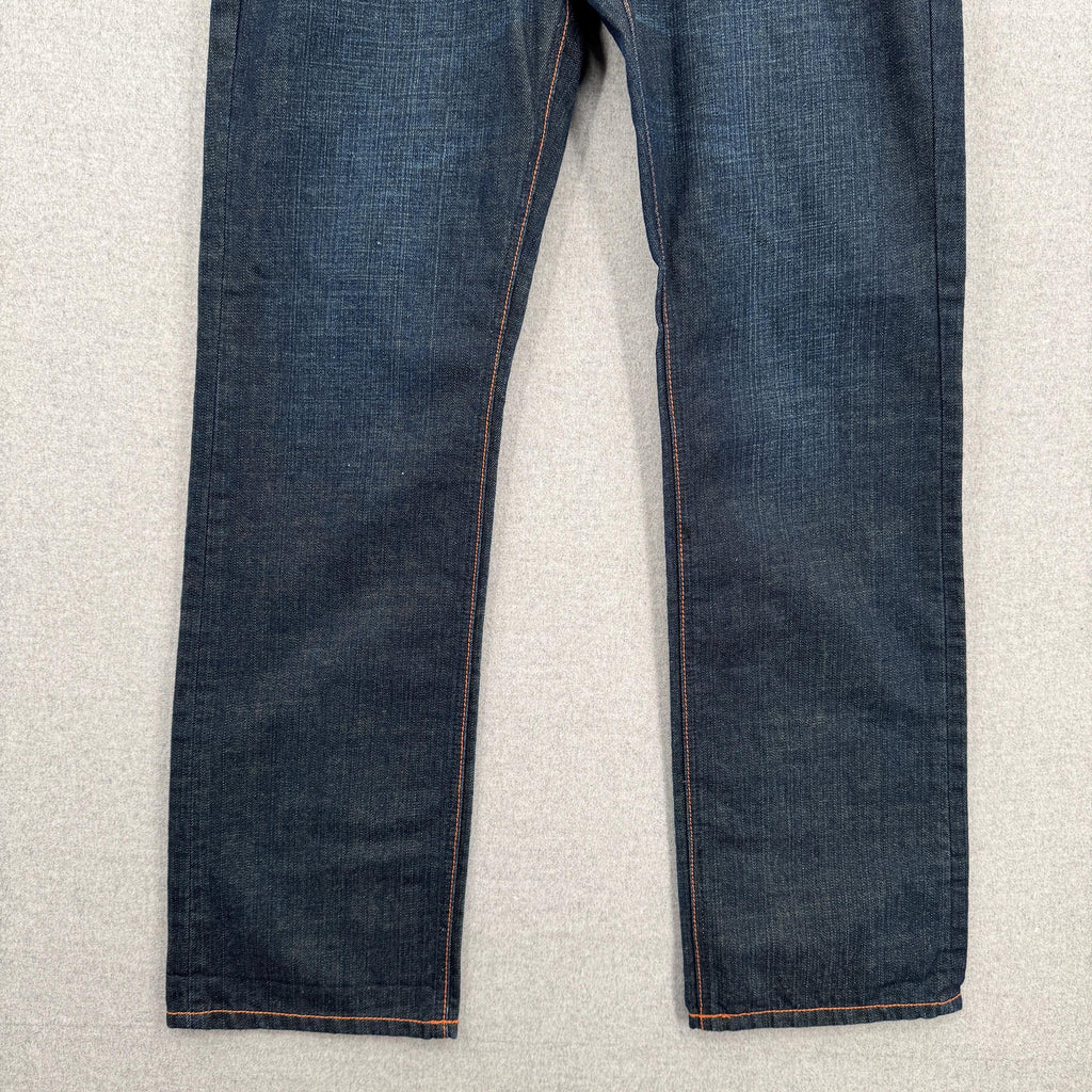 Pair of blue jeans on a light gray surface