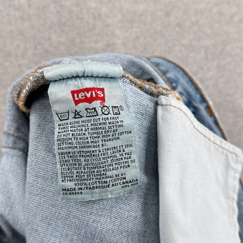 Levi's label on a denim garment with a neutral background. 100% cotton made i Canada