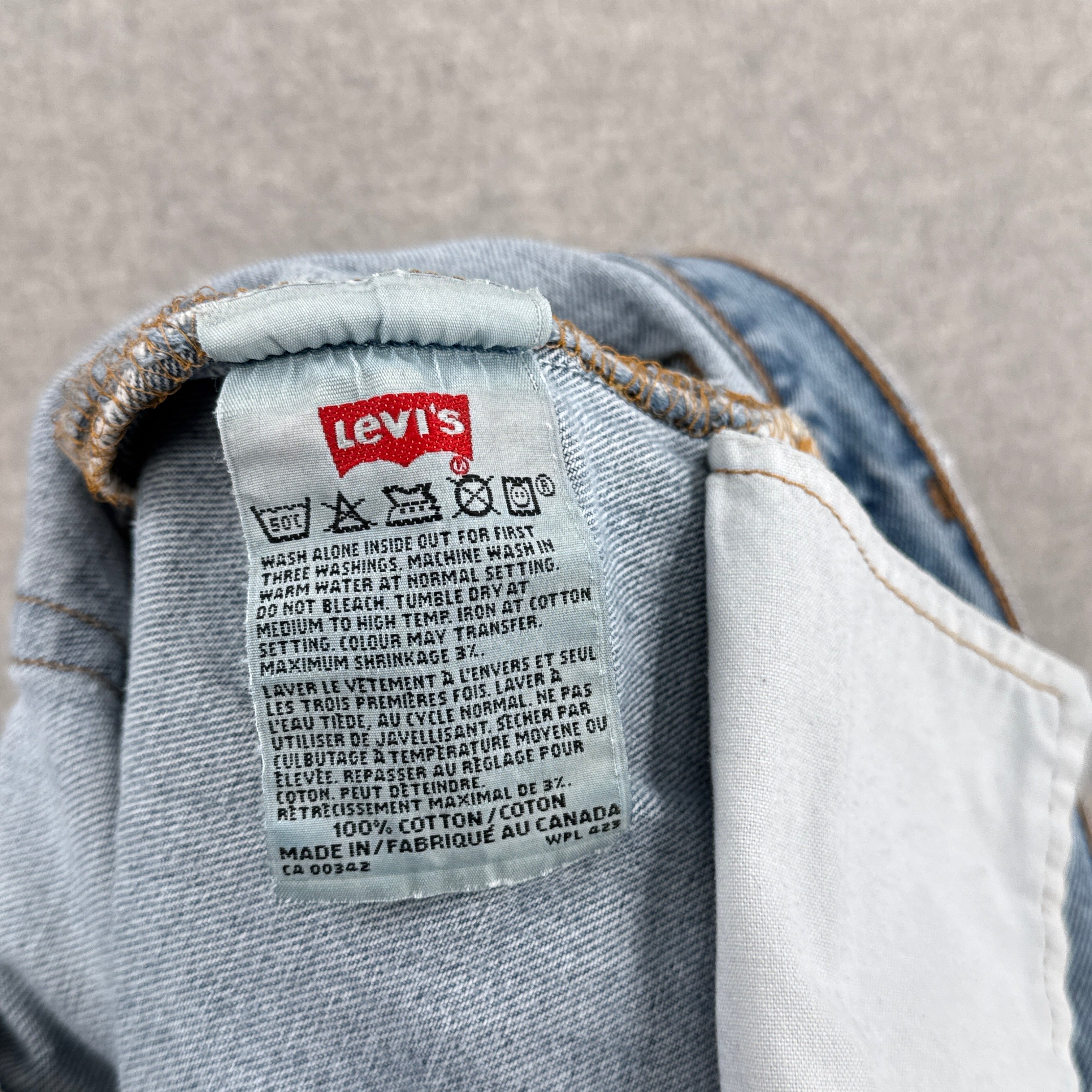 Levi's label on a denim garment with a neutral background. 100% cotton made i Canada