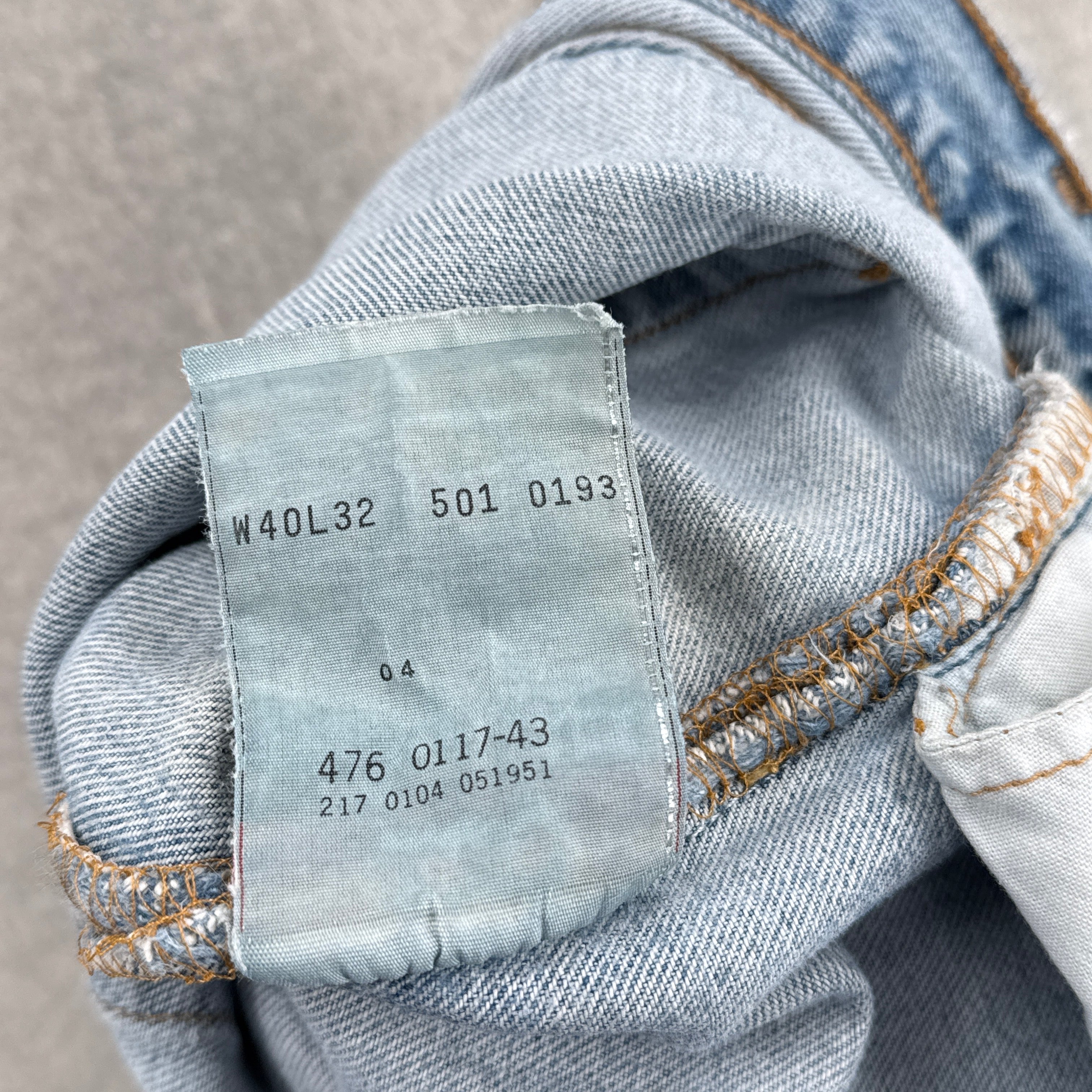 Close-up of a denim fabric with a label on a gray background