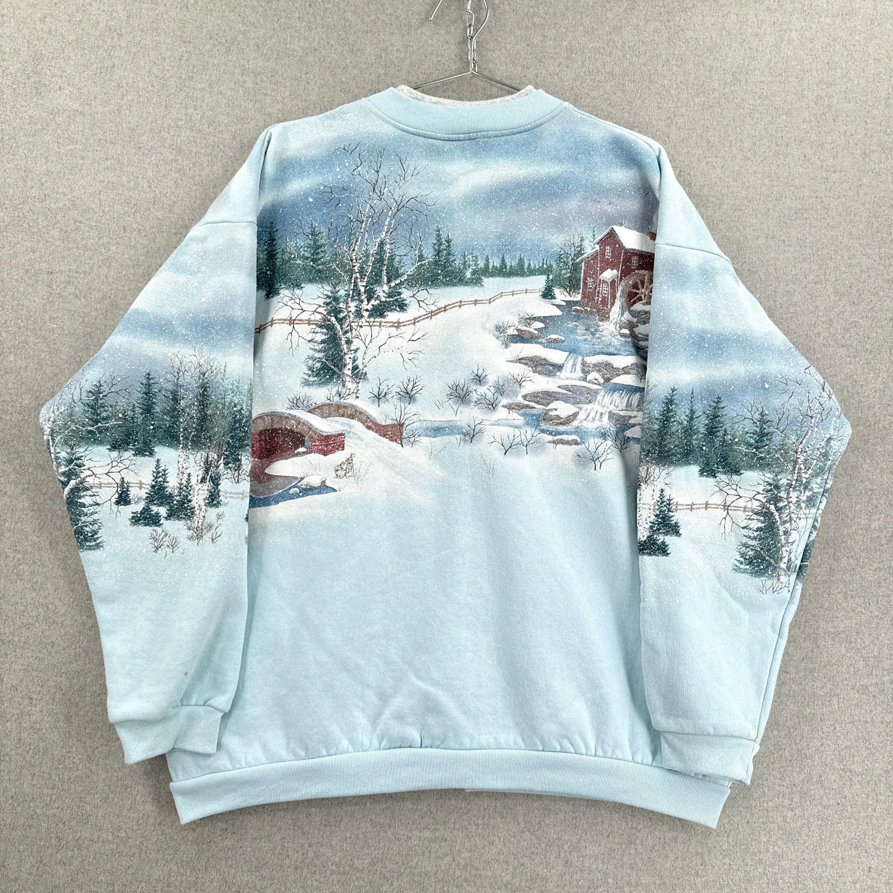 Sweatshirt with a winter scene print on a beige background