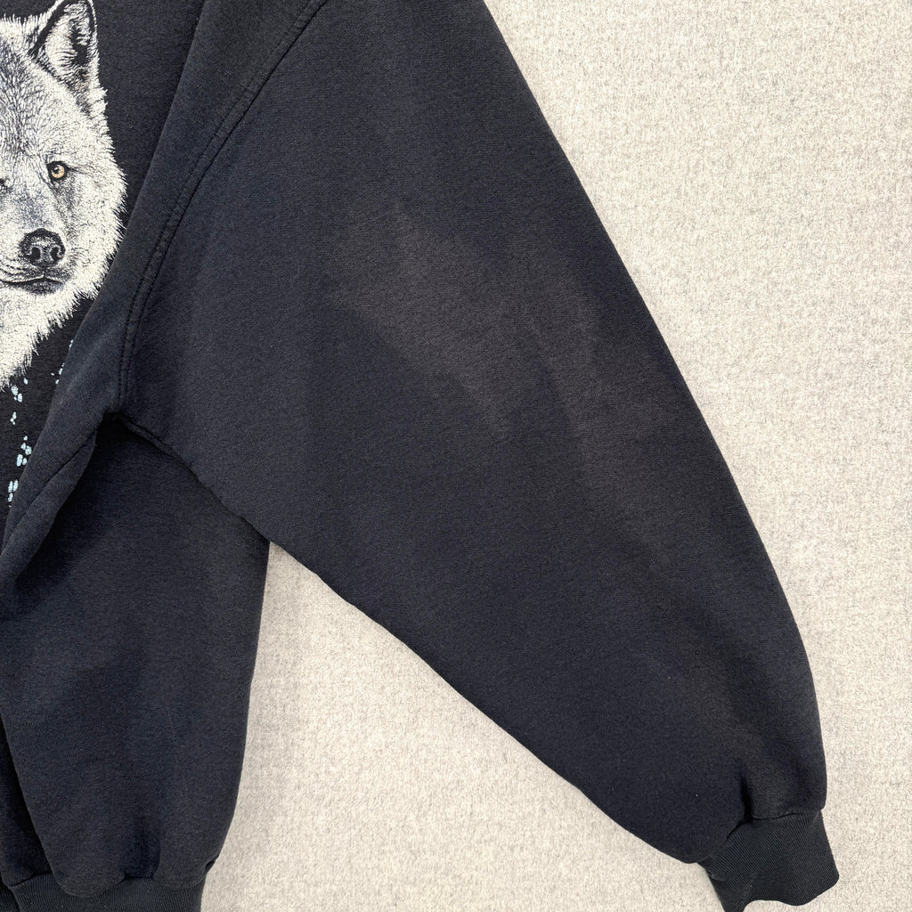 Black hoodie with a wolf graphic on a light gray background. Shows sleeve with lightened discolouration