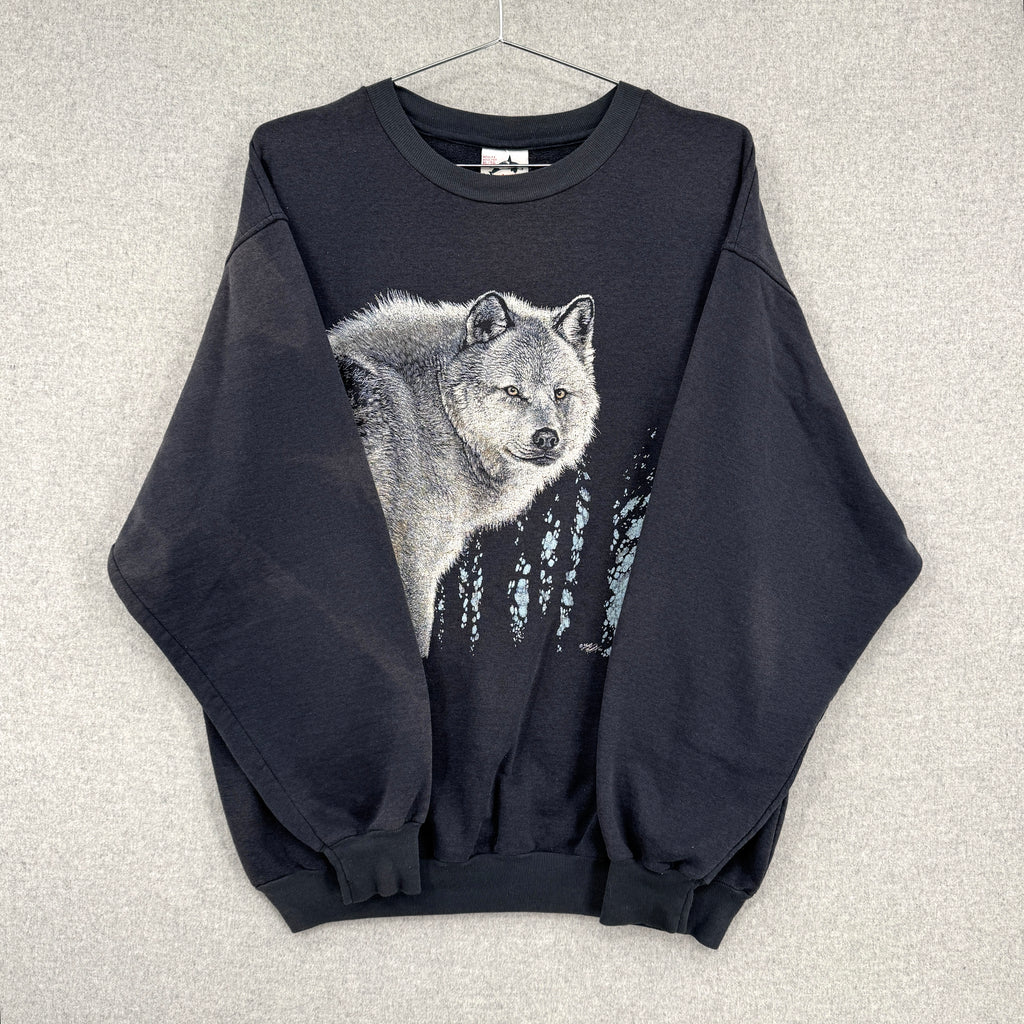 Black sweatshirt with a wolf graphic on a textured gray background. Sleeves folded over showing discolouration